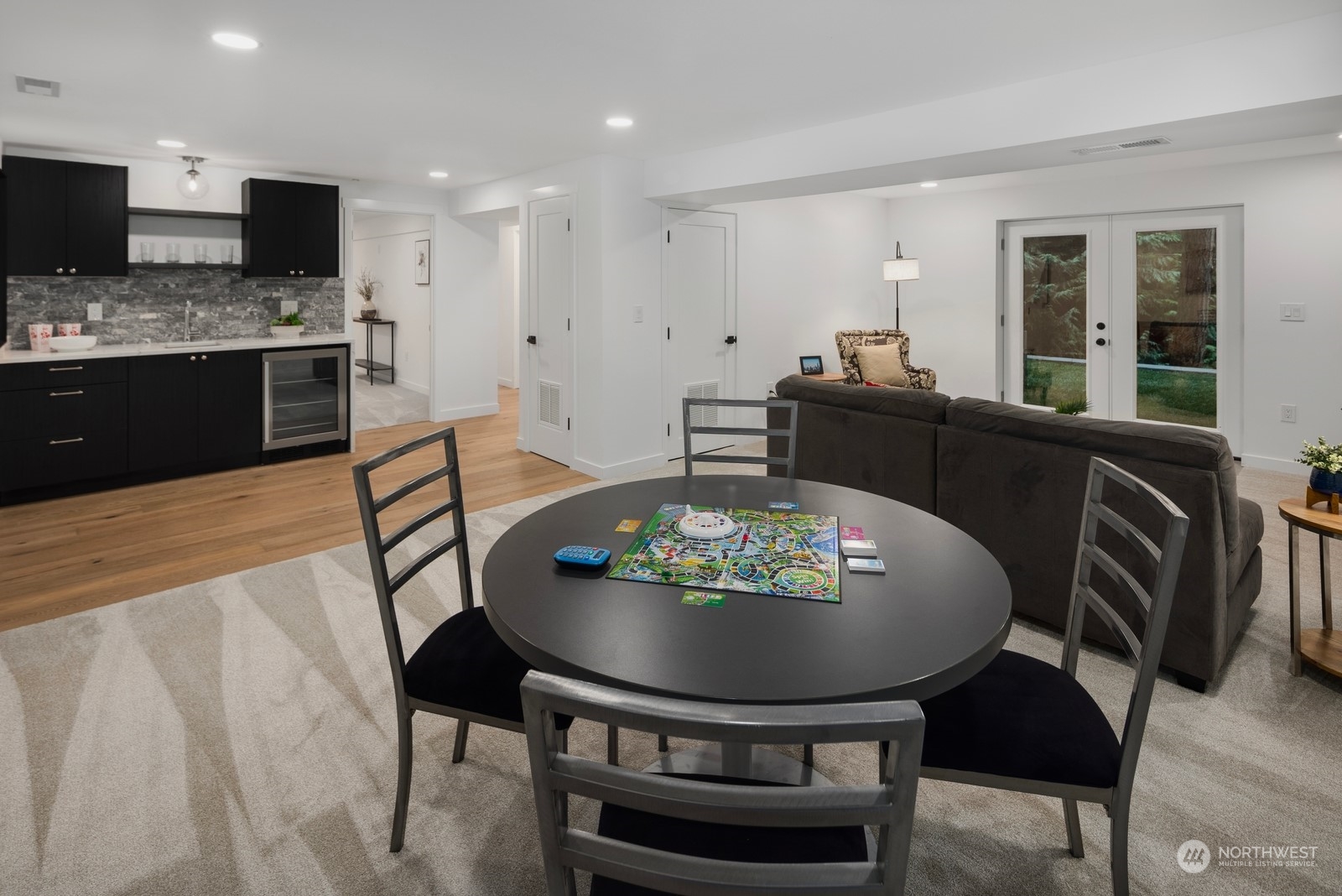 Lower level kitchenette with full height backsplash, beverage fridge and custom designed cabinets.