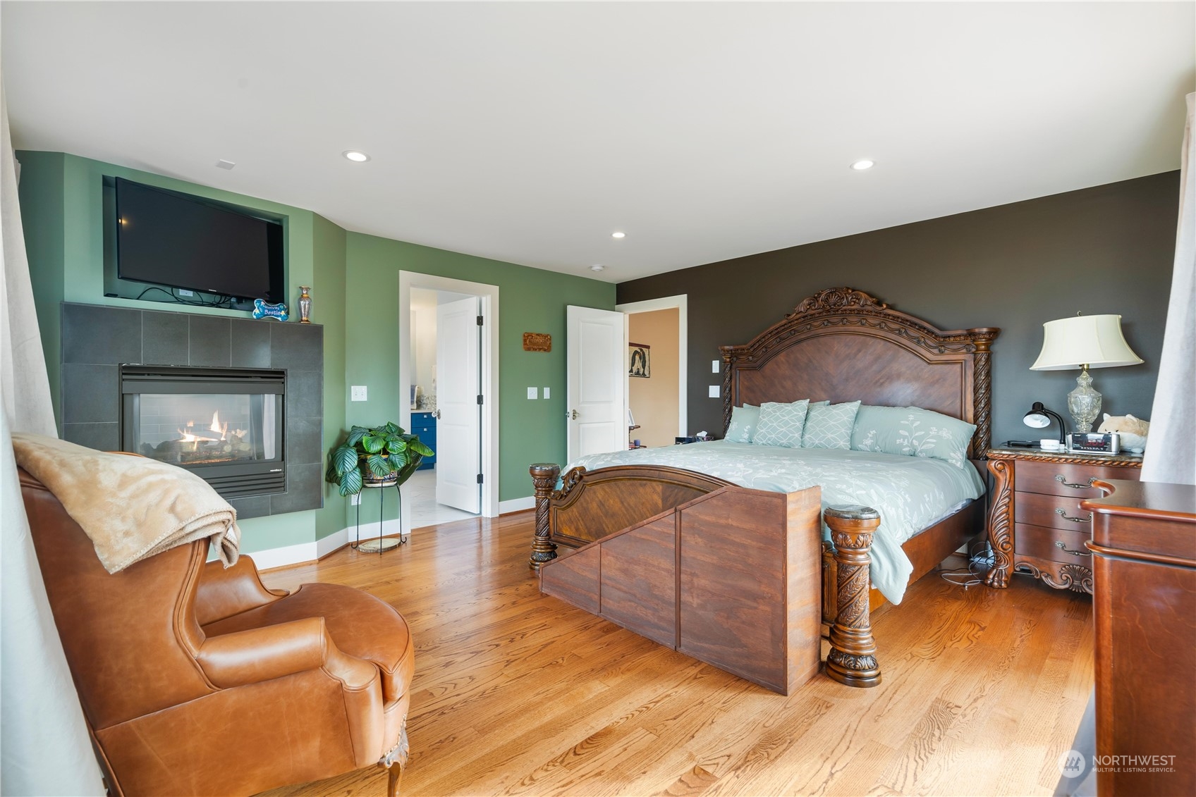 Primary bedroom with gas fireplace and entrance to large view deck.