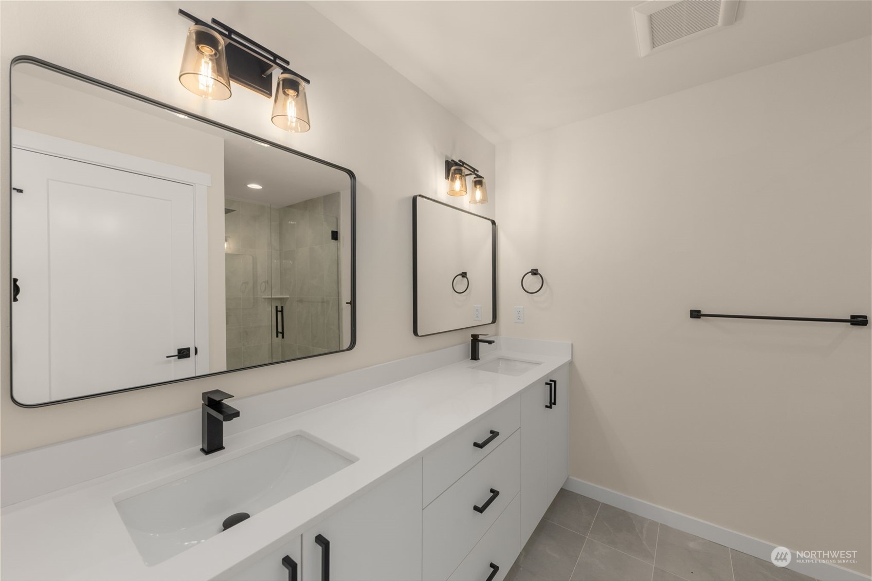 A closer look at the streamlined tub and tile surround, perfect for unwinding after a long day. Thoughtful shelving adds functionality without compromising style.