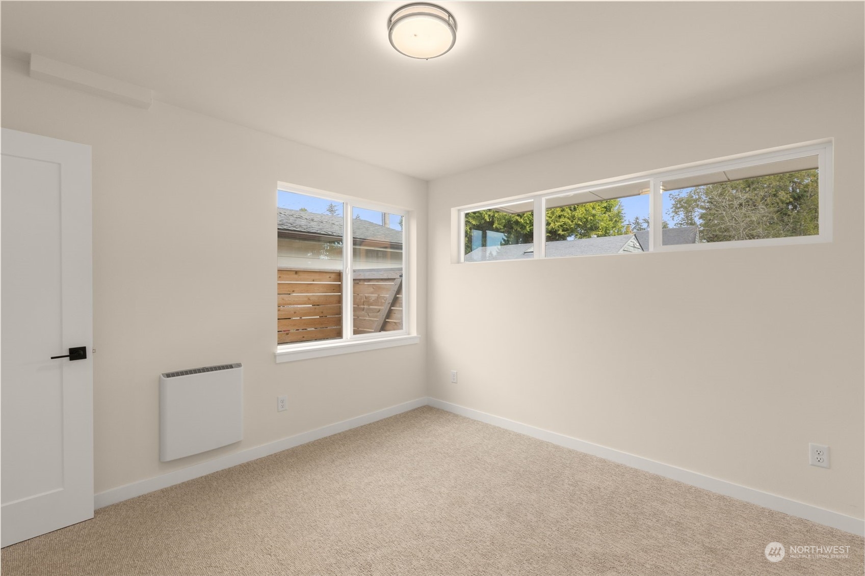 A serene secondary bedroom offers the perfect retreat, with soft carpets and ample closet space to keep things tidy and organized.