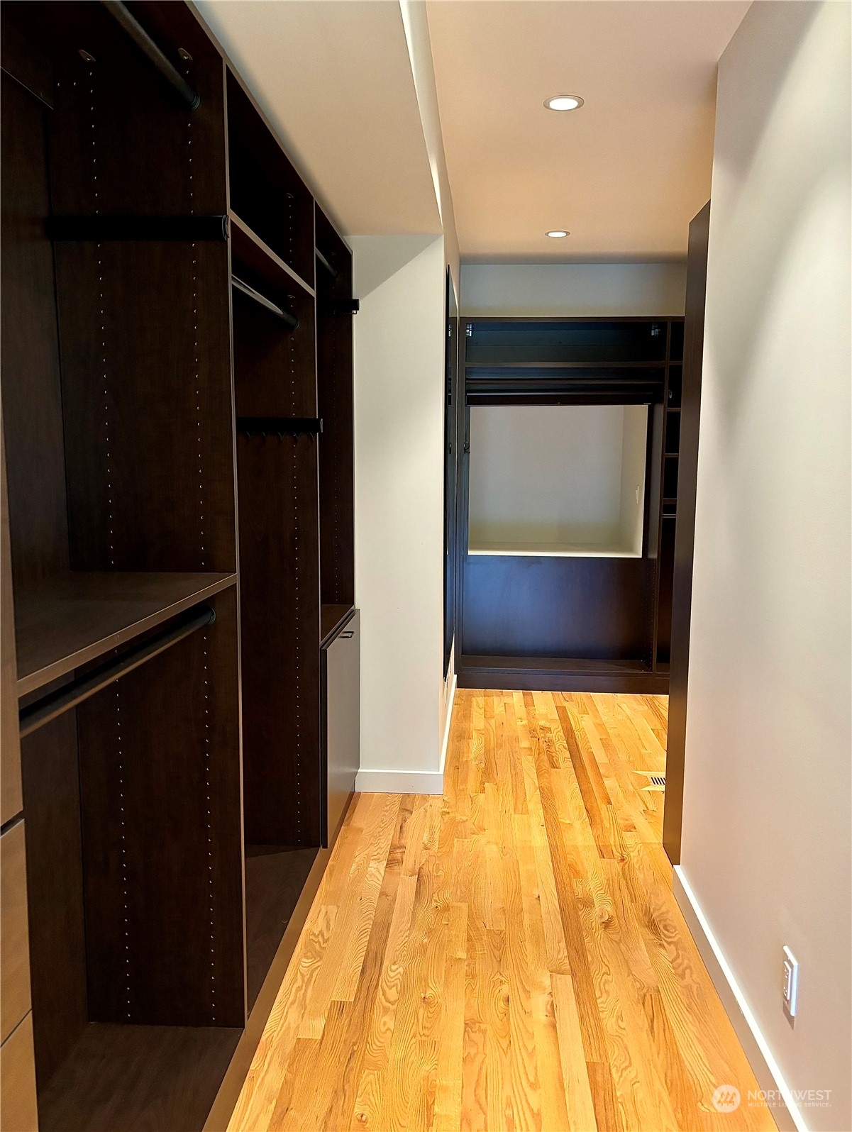 Large walk in closet with custom built ins.