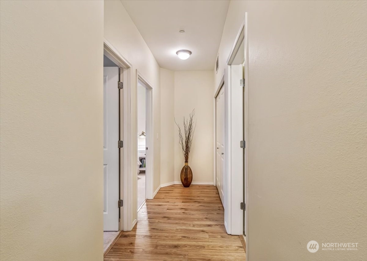 Down the hall bathroom and Laundry to your right, Primary and additional bedroom to your left! Flooring in bedroom has been changed to LVP since this photo was taken.