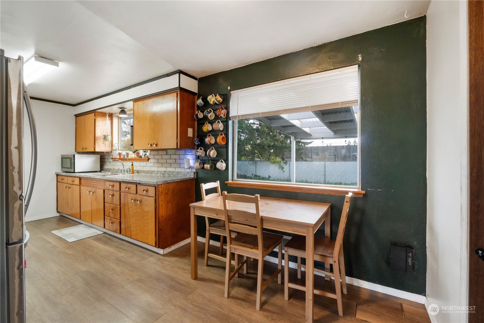 The large window overlooks the back yard.  Notice the covered patio.  To the right is the door that leads to the utility room and the large master bedroom that was a garage conversion.