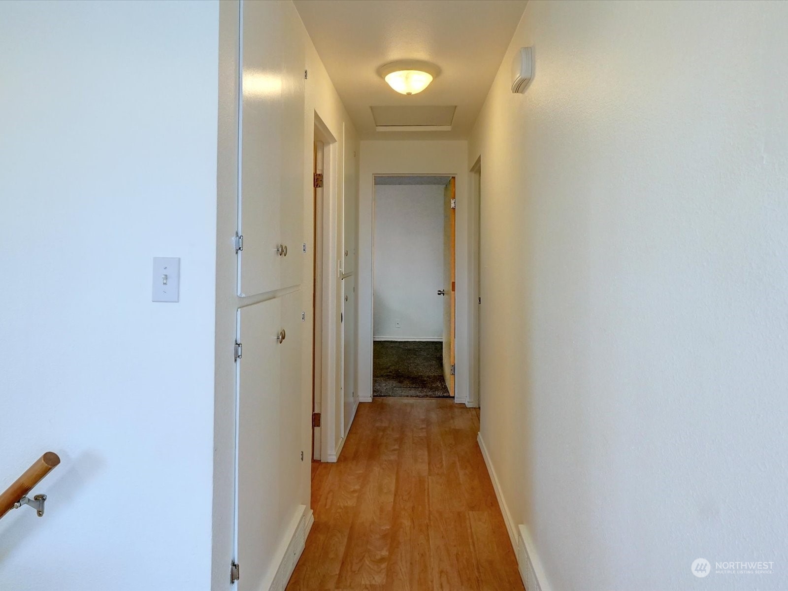 Hallway leading to bathroom on left and two bedrooms down the hall.