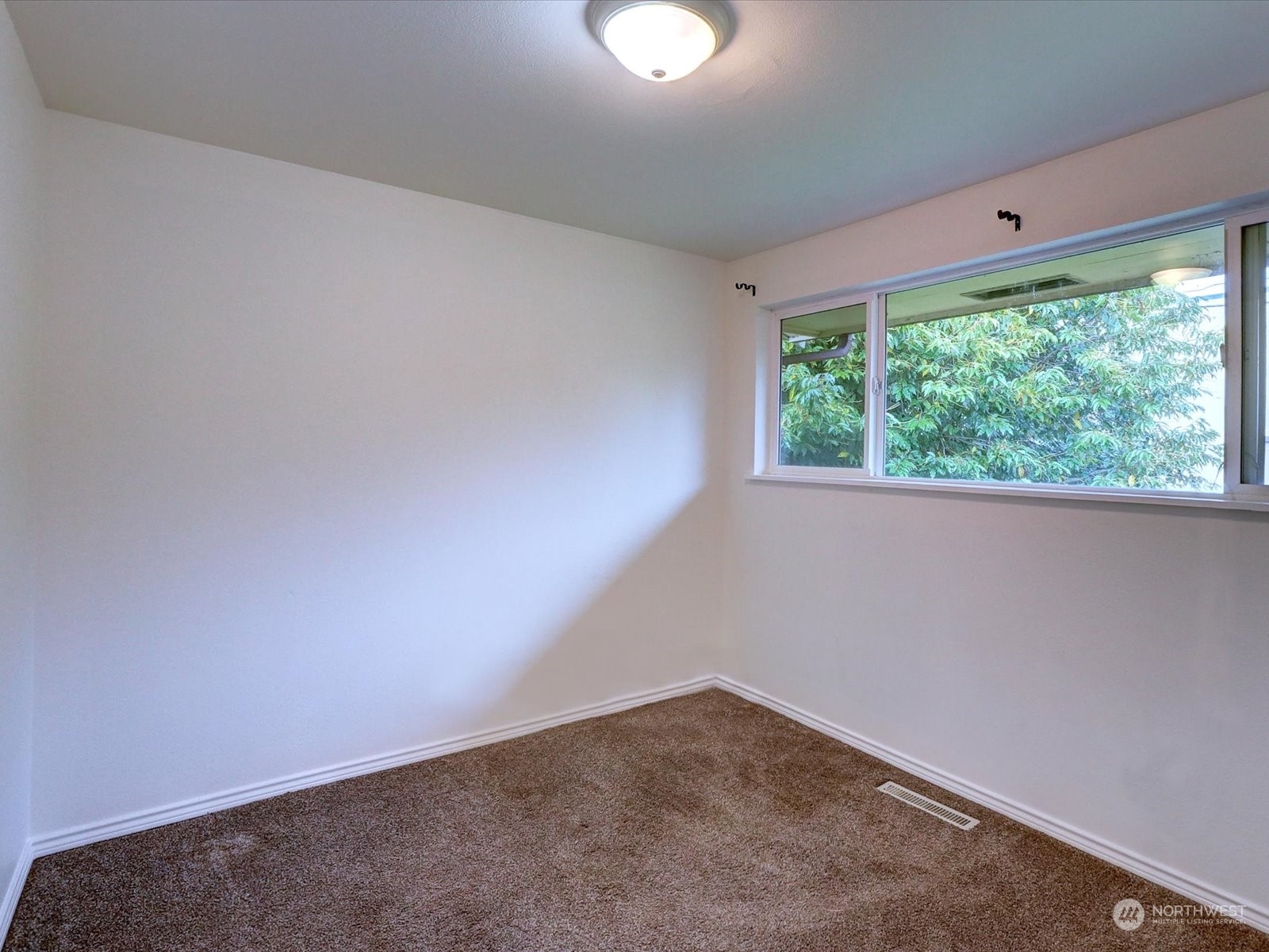 Upper level bedroom facing backyard.