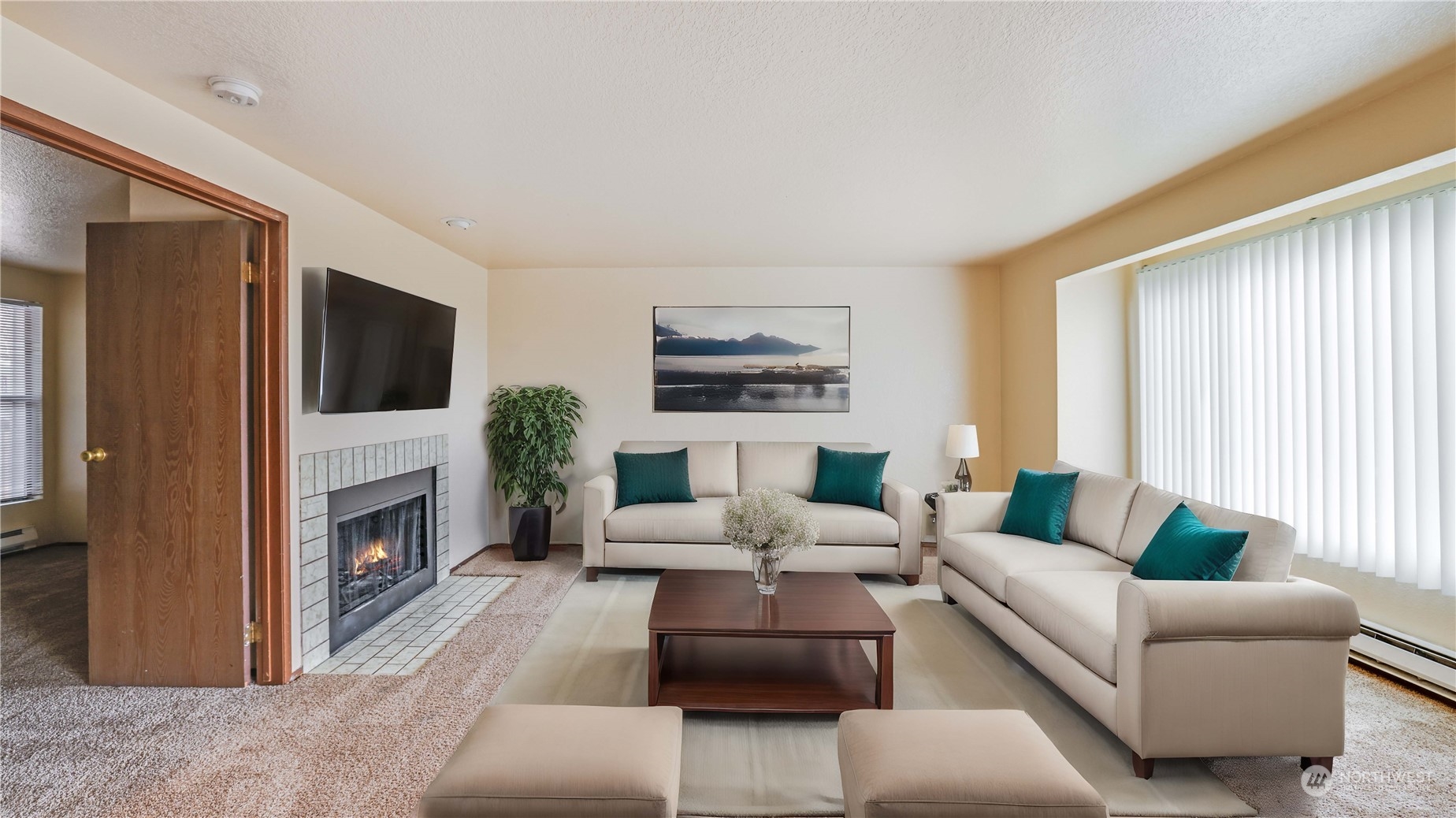 Living room offers the perfect ambiance with the natural light and the cozy fireplace. **Virtually Staged**