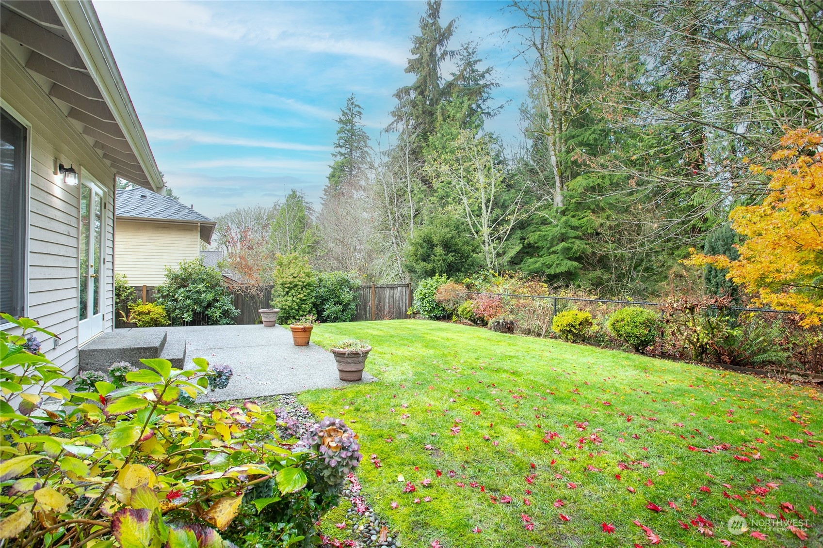 Fenced backyard backs to green space