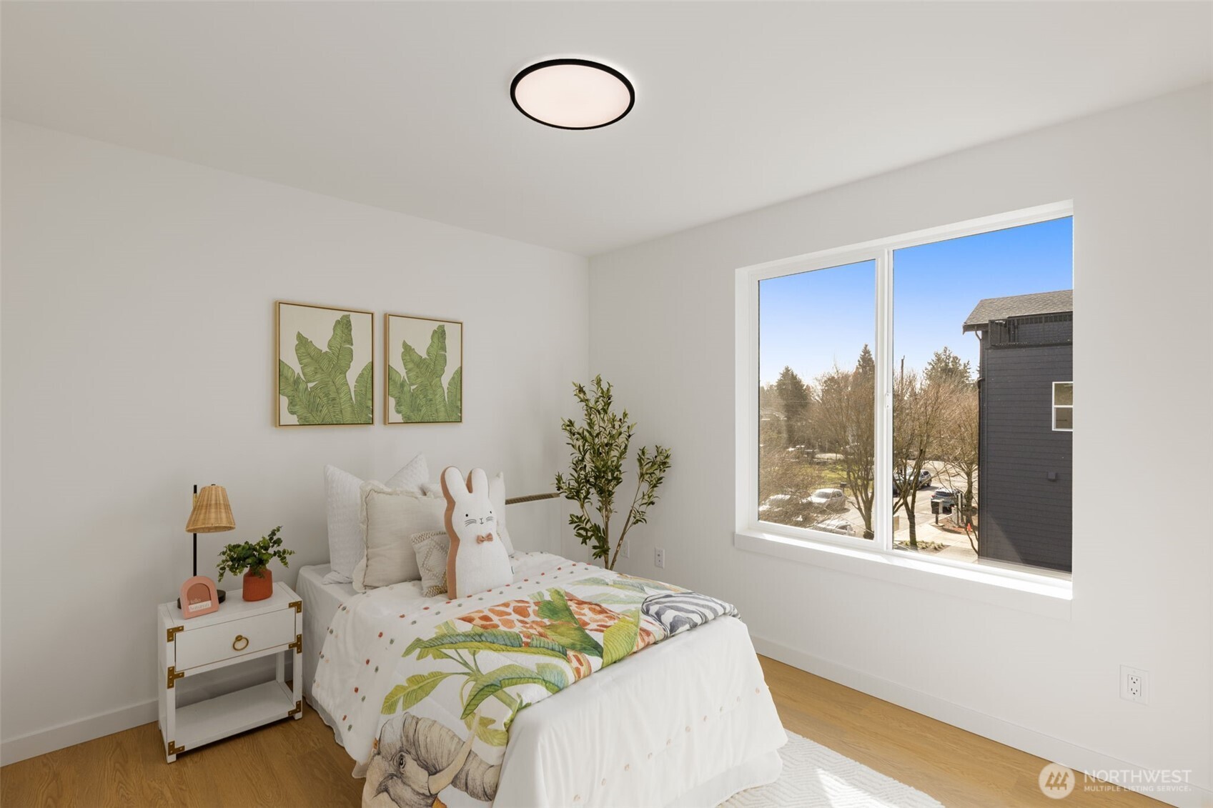 A cheerful, sunny bedroom ready for playtime, nap, or study time, this space is versatile.