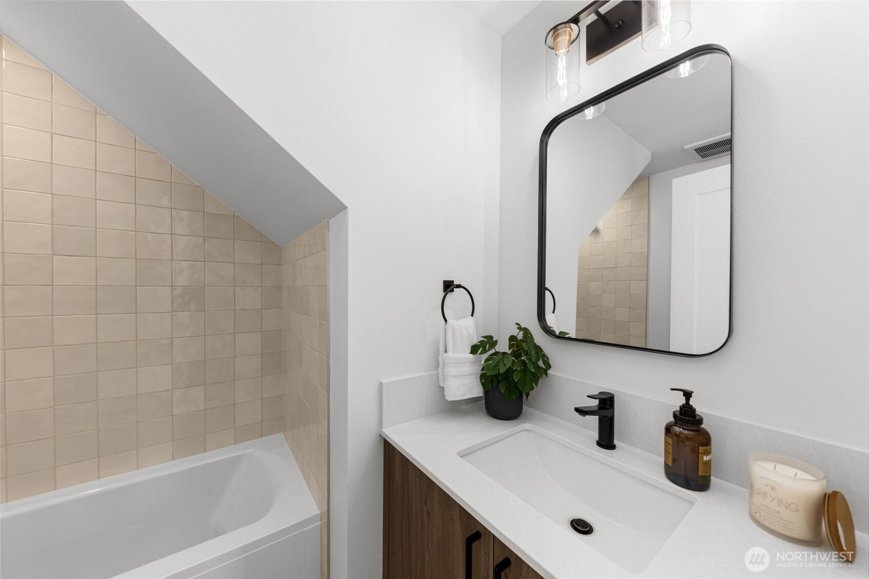 Modern touches meet cozy charm in this bathroom tucked—sleek fixtures and warm tile make it pop.