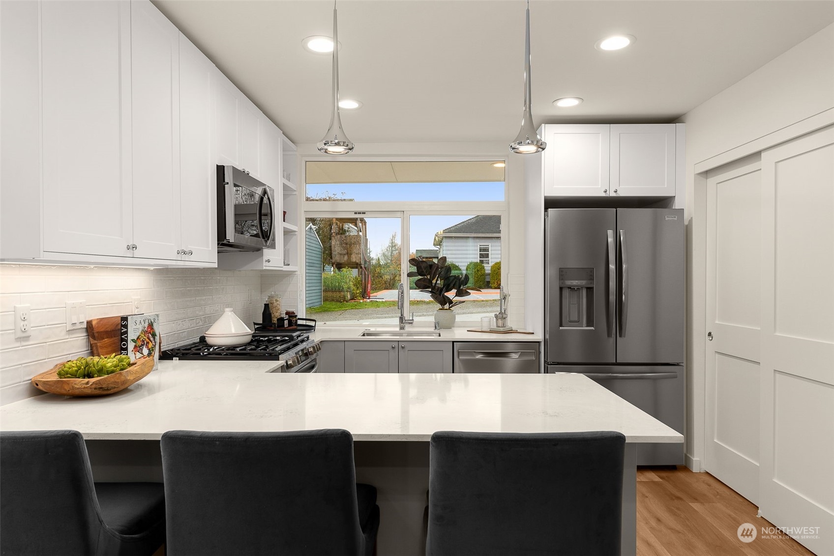 The kitchen offers a seamless connection to the outdoor surroundings, serving as the heart of the home and an ideal space for culinary exploration.