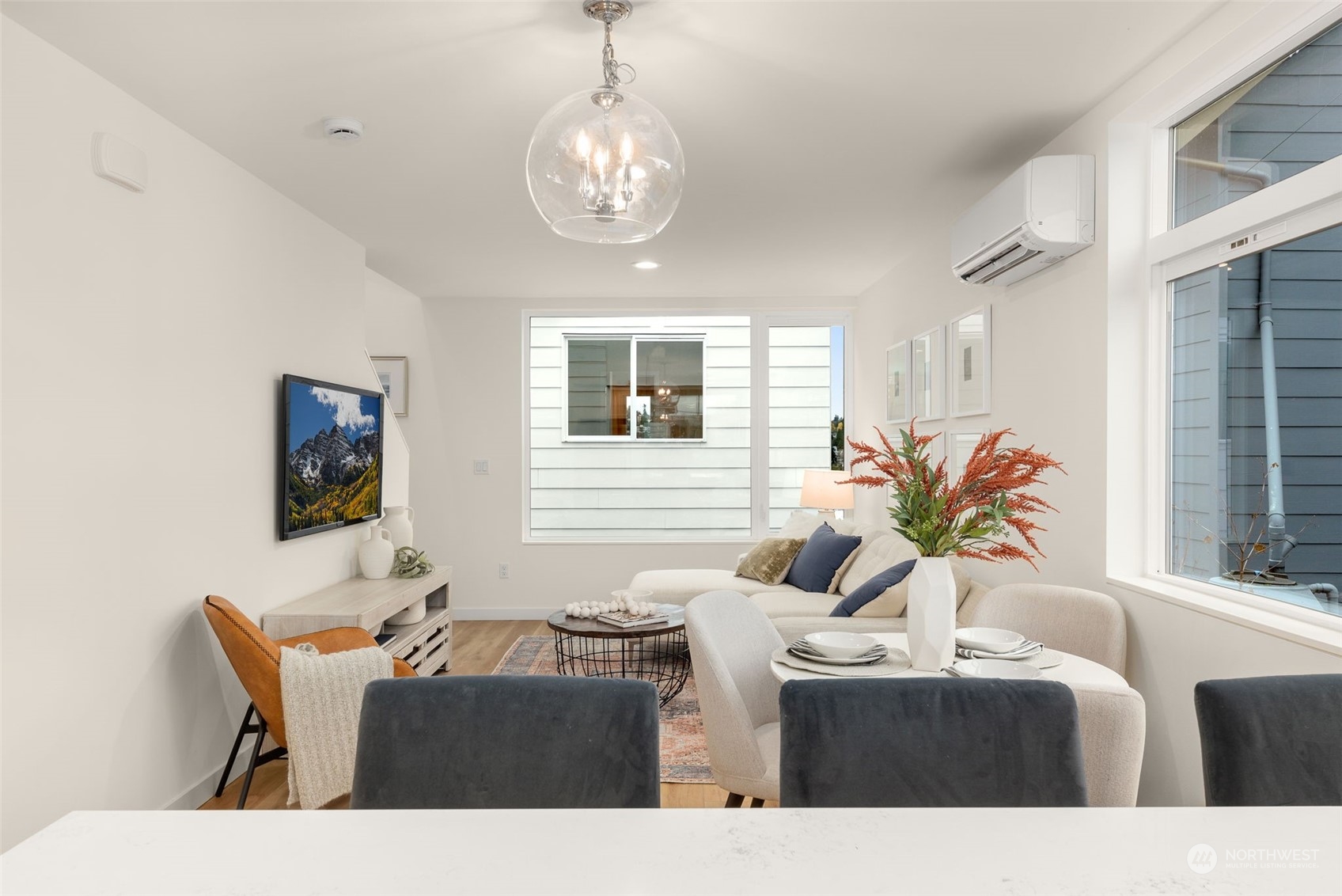 A welcoming living space drenched in natural light, perfect for relaxing evenings. The warm tones and elegant decor make this space feel like home.