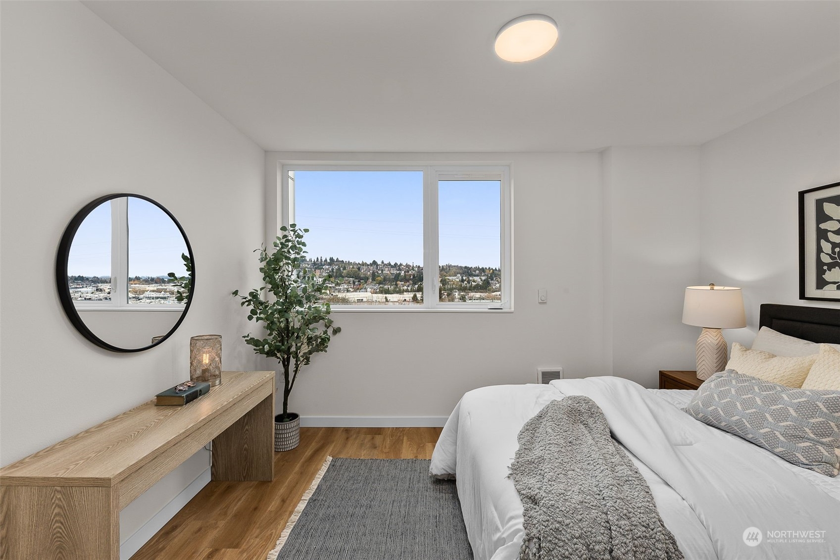 A serene retreat with stunning views from your bedroom window. This space is bathed in natural light, offering a cozy yet contemporary vibe to unwinding after a long day.