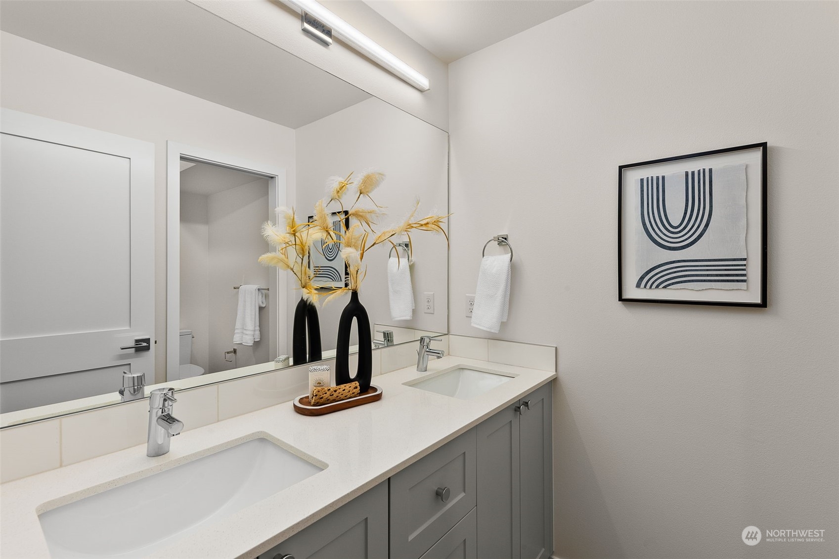 Modern elegance meets practicality in this spa-inspired bathroom. Dual sinks and sleek finishes create a harmonious blend of style and functionality.