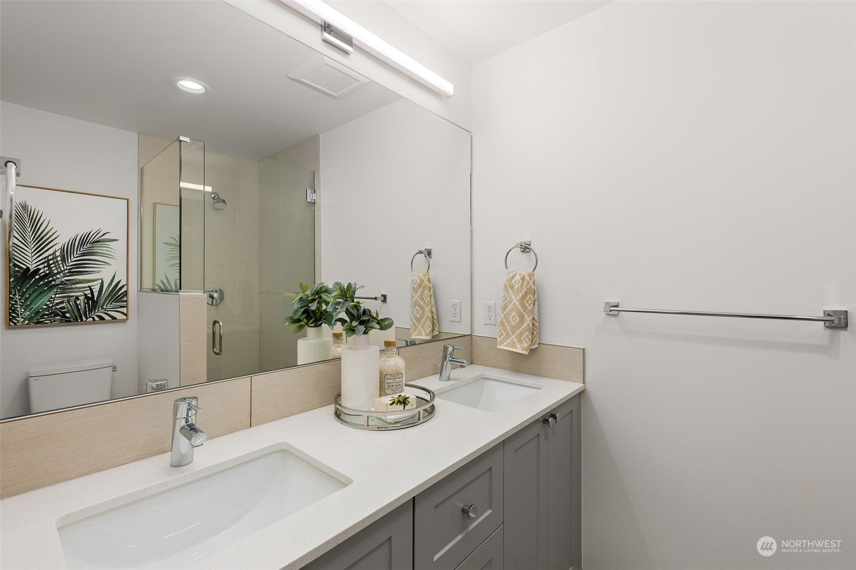 This primary bathroom exudes sophistication with dual sinks, modern fixtures, and sleek cabinetry. Perfectly designed for convenience, the glass-enclosed shower adds a spa-like touch to your daily retreat.