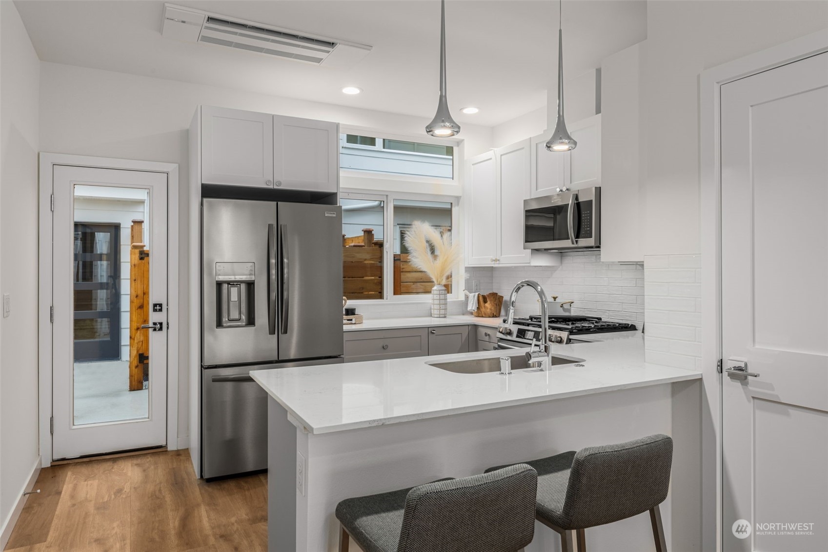 Prepare meals in a state-of-the-art kitchen featuring stainless steel appliances, quartz countertops, and ample storage. A space designed to inspire your culinary creativity.