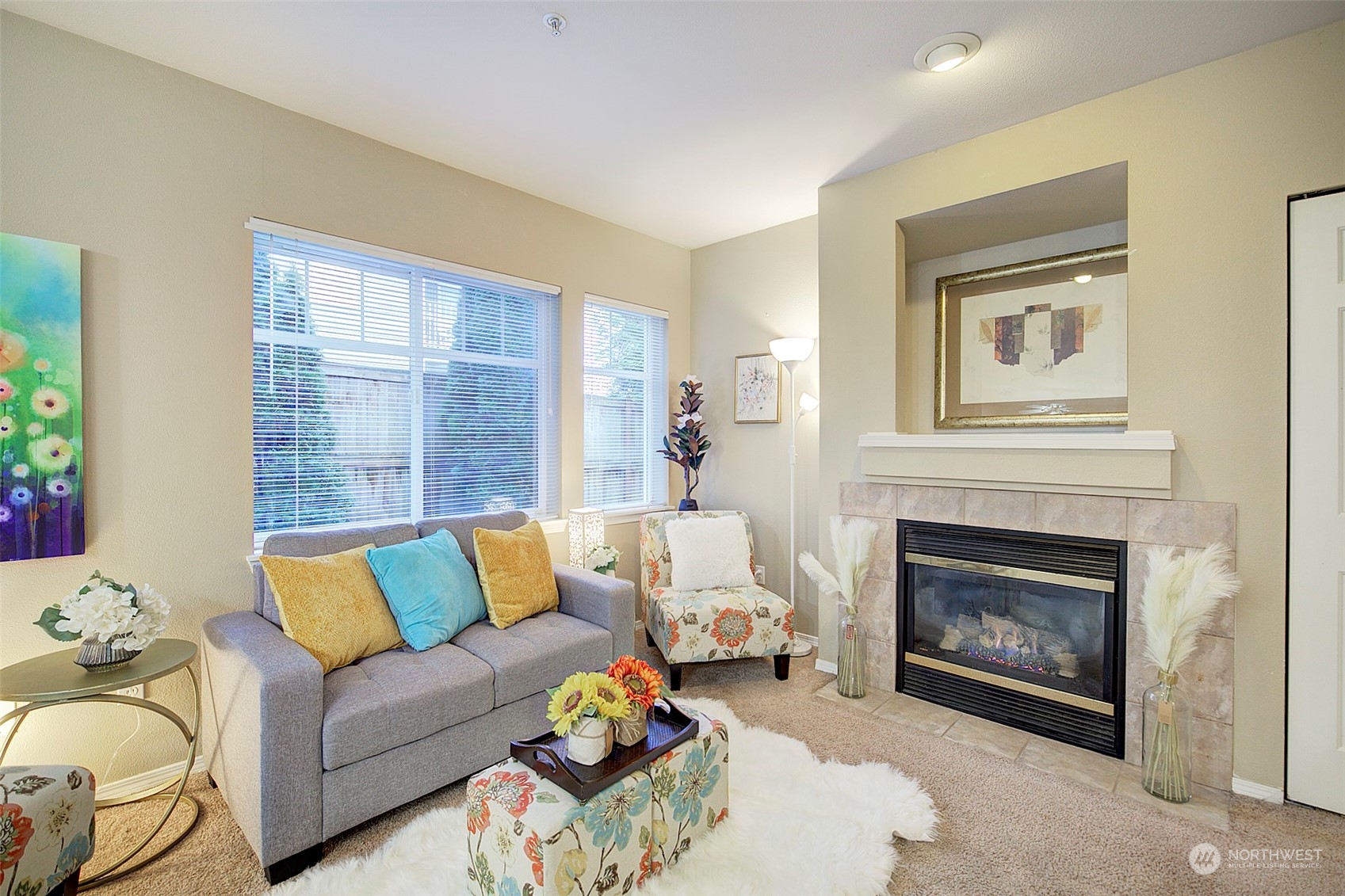 Open living room with gas fireplace and windows w/natural light