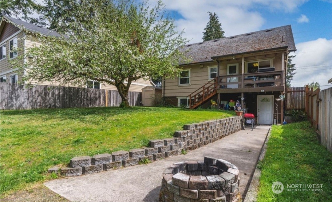 Large back yard and access to lower unit/ADU. Photo prior to new roof.