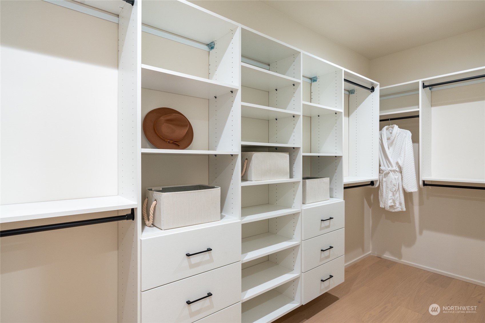 Discover elegance and organization in the primary suite's custom built-in closet.