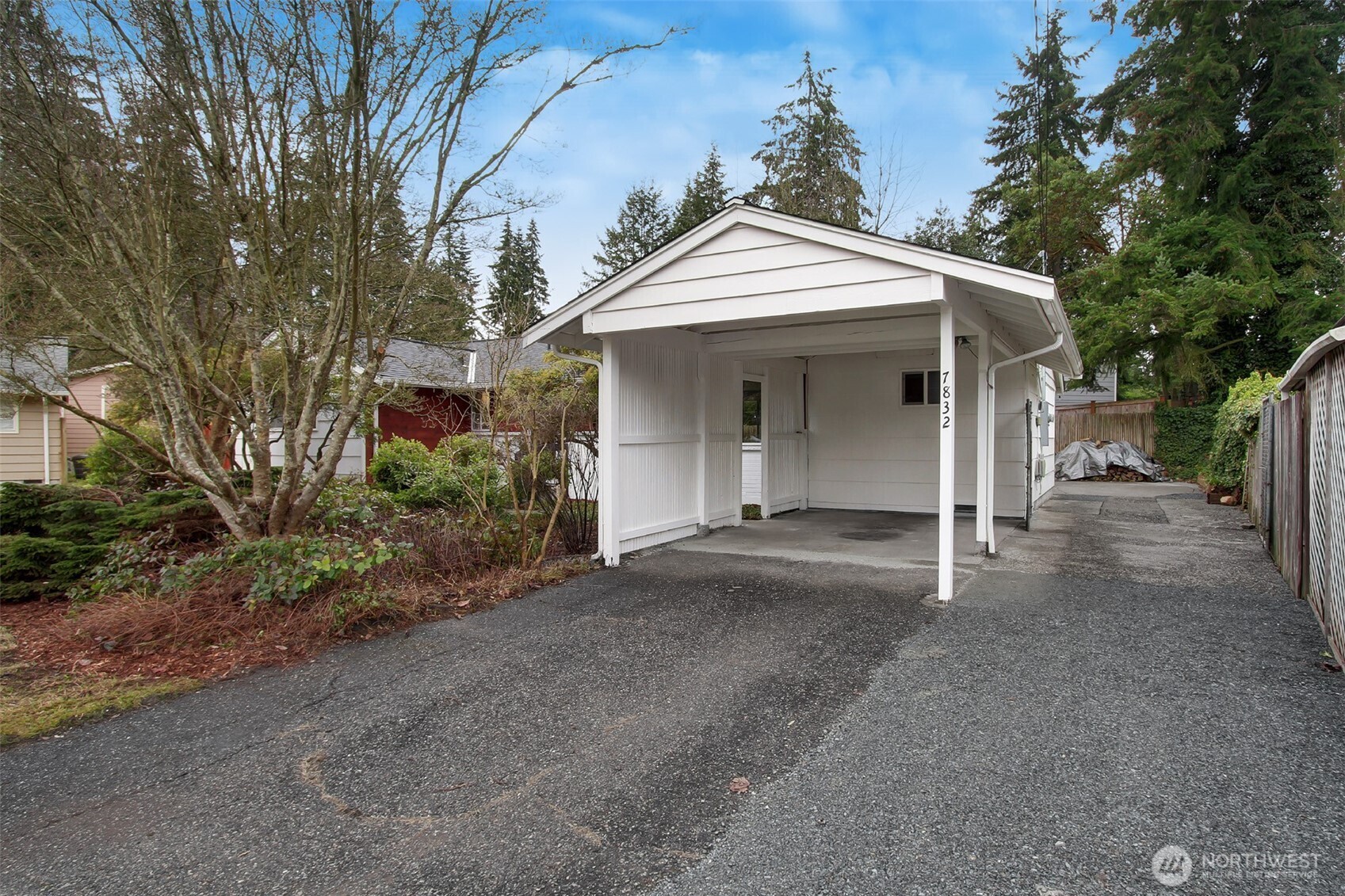 Large carport and driveway. The driveway at one time wrapped all the way around to the garage.