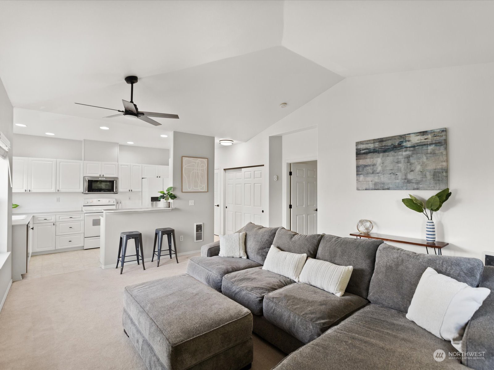 Spacious living room joins the dining area and kitchen.