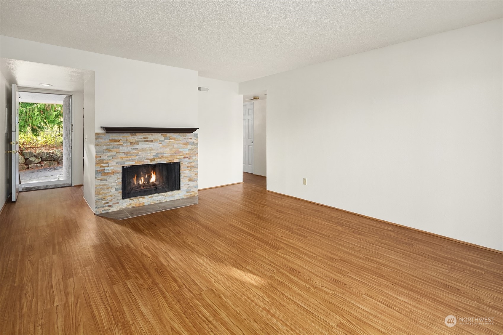 A wood fireplace is a focal point in the living room.