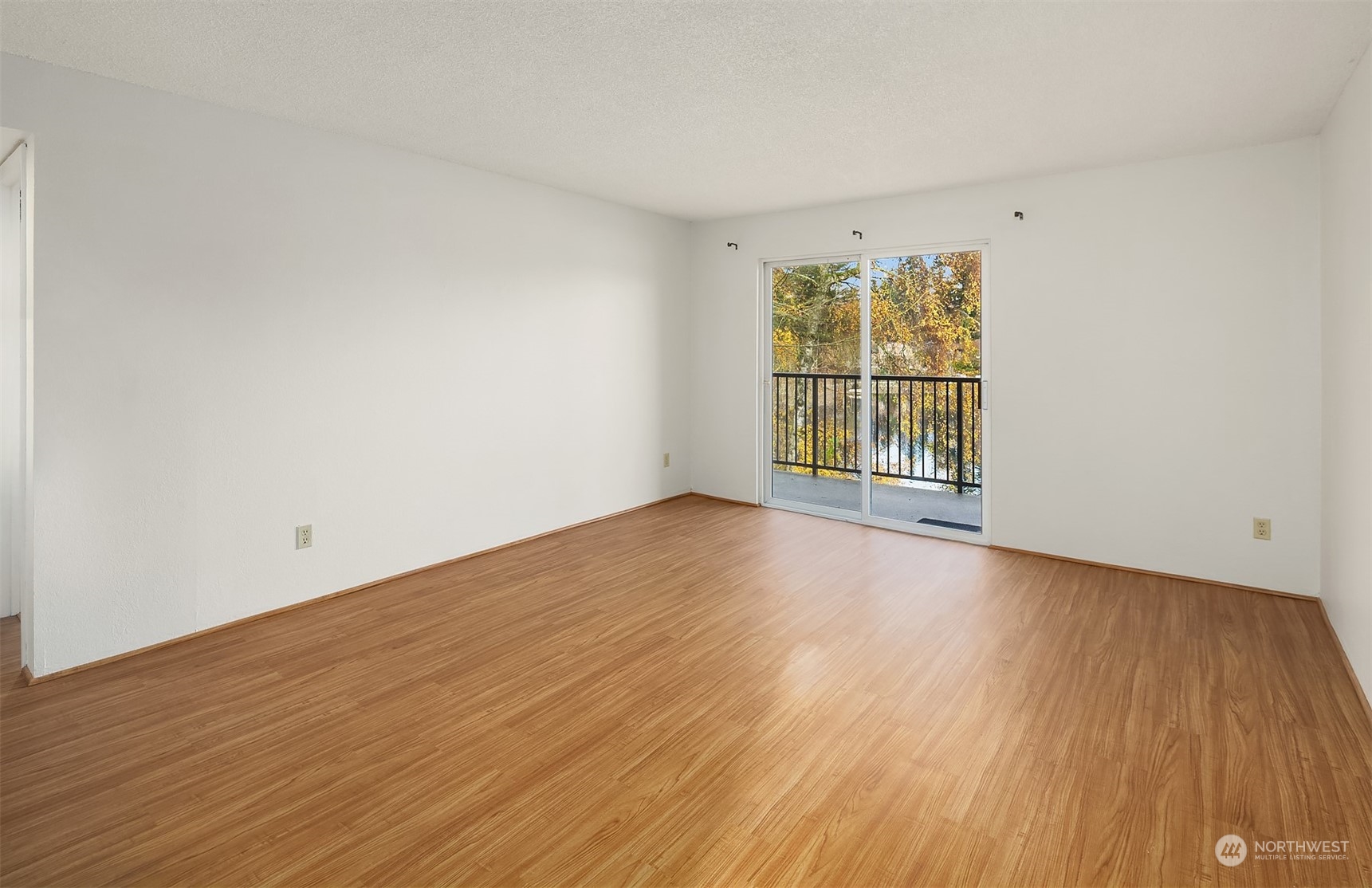 The living room with views has a glass slider to the covered deck.