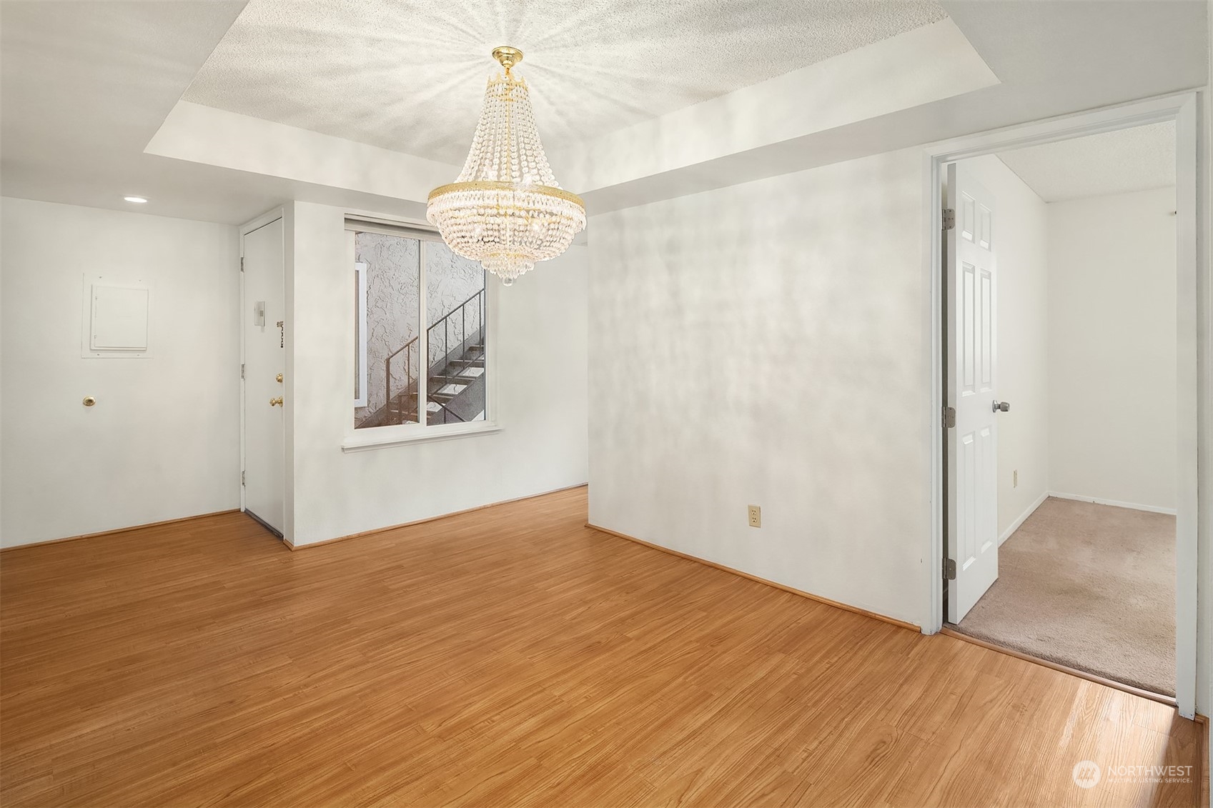 The entry opens to the dining room with charming chandelier.