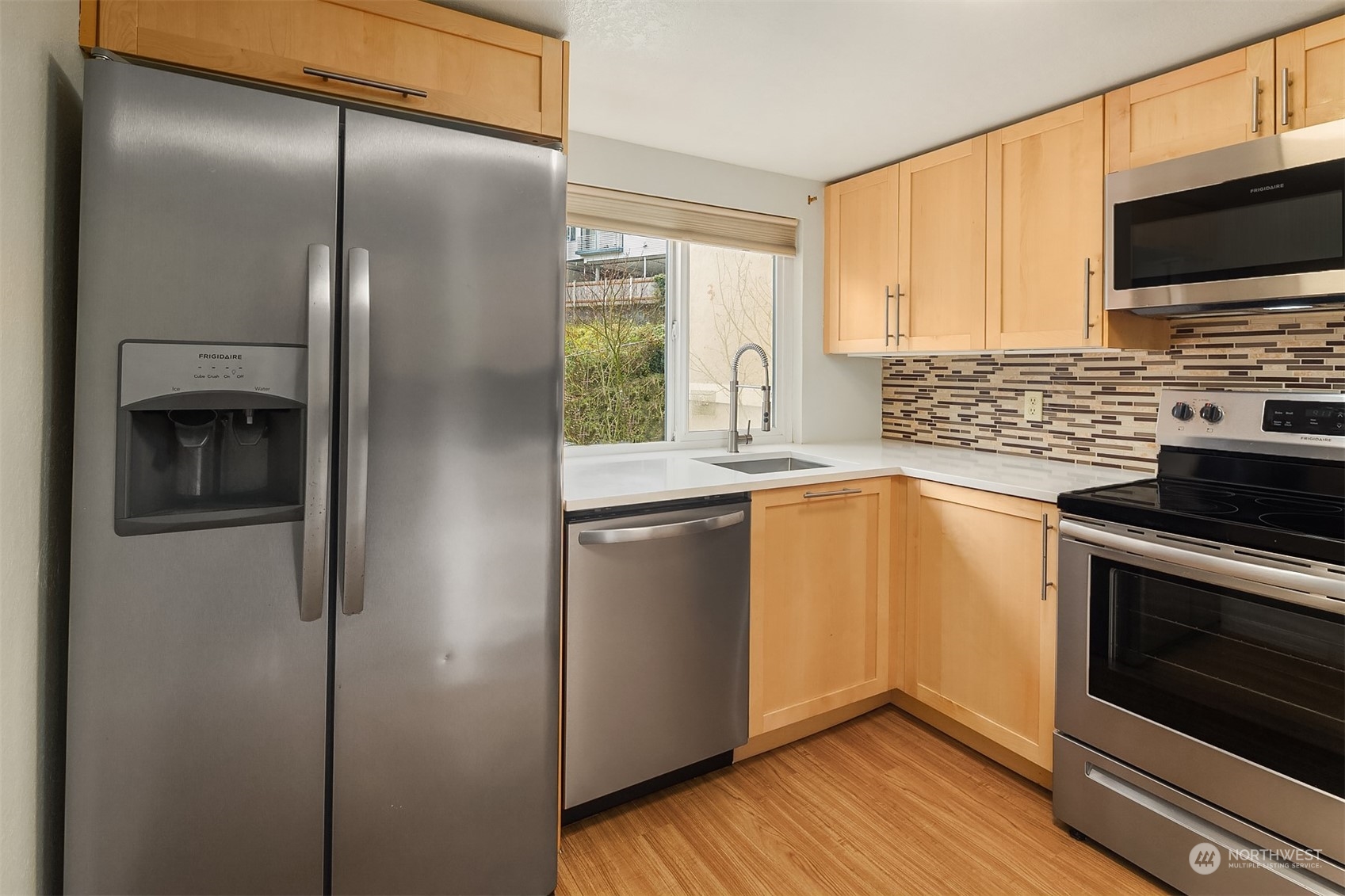 The updated kitchen has stainless steel appliances and looks.