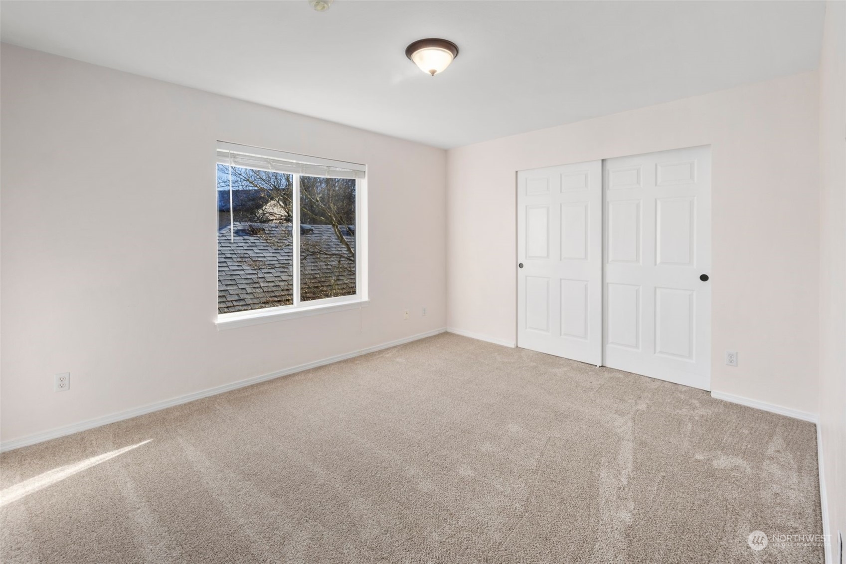 Second bedroom overlooks the garages. Lots of light in here as well.