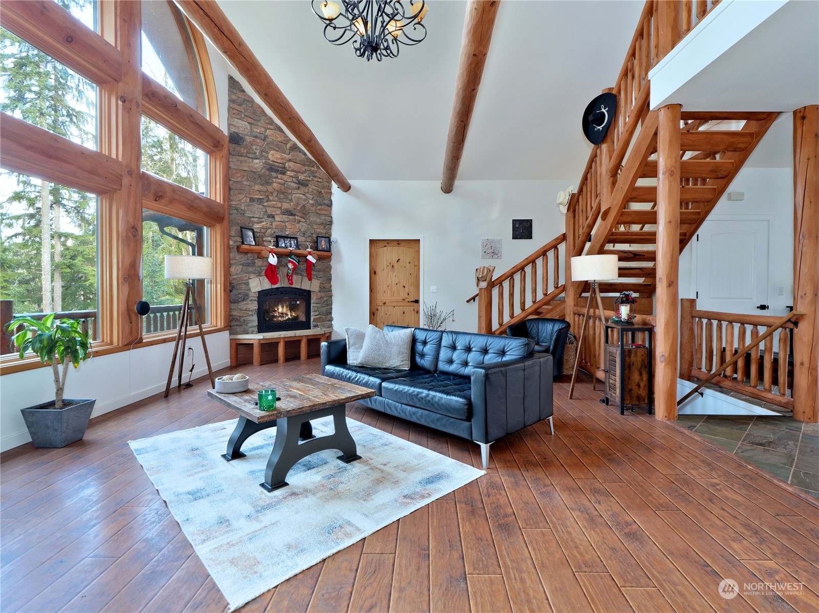 GREAT ROOM WITH FLOOR TO CEILING WINDOWS , STONE FIREPLACE , EXPOSED BEAMS