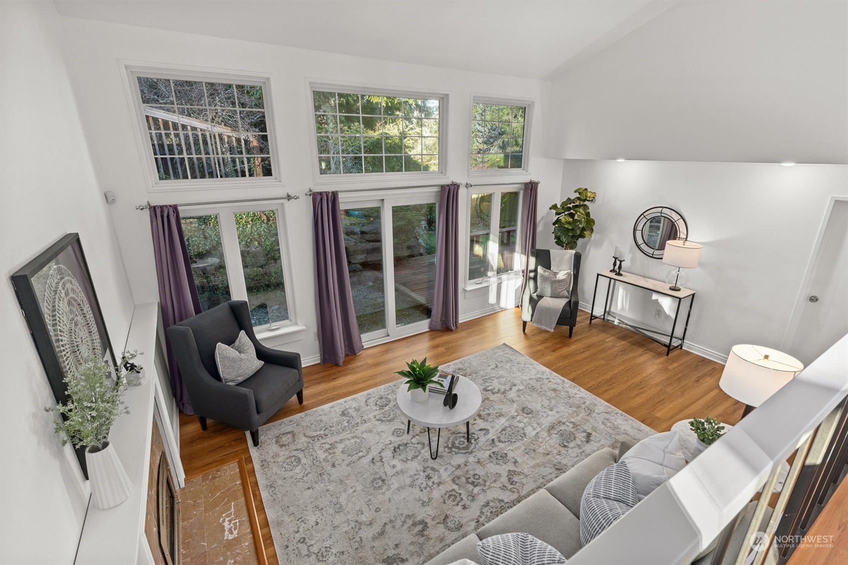 Spacious living room featuring French doors that open to the backyard