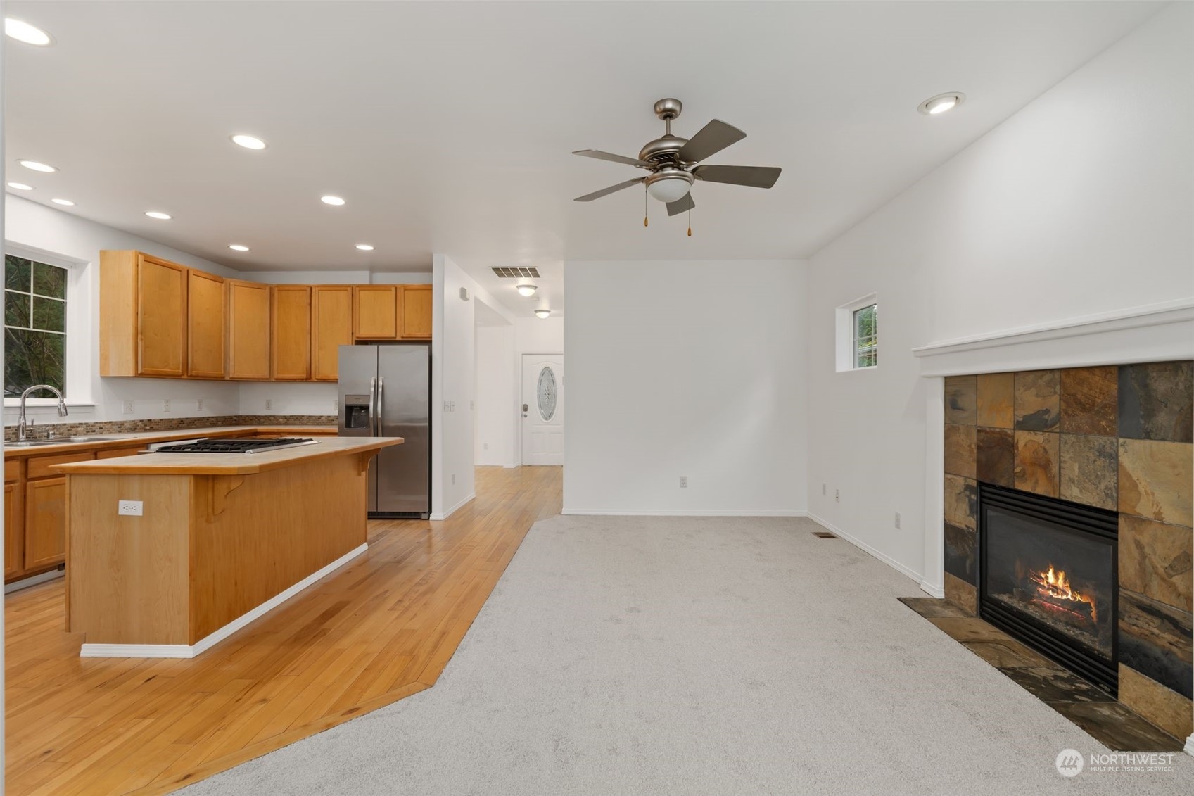 Living Area: Open floor plan with fireplace and hardwood floors.