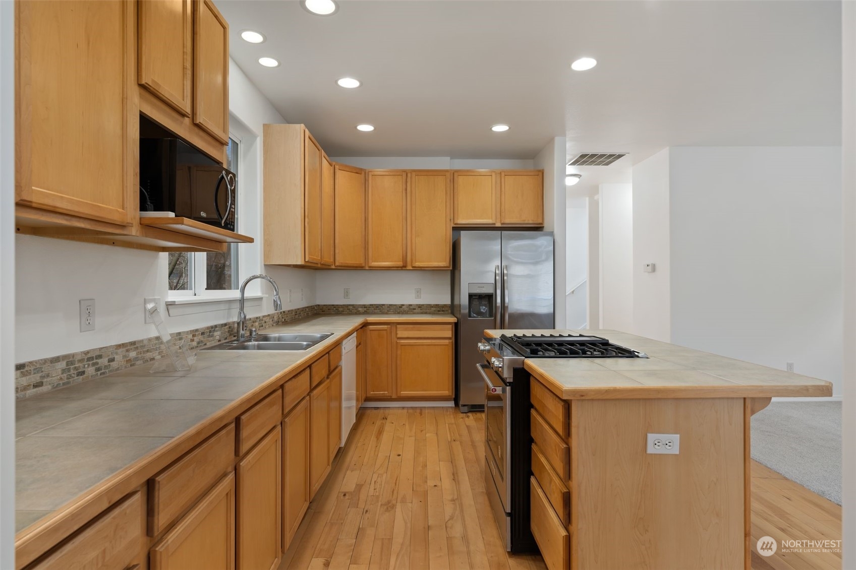 Kitchen: Spacious with wood cabinets