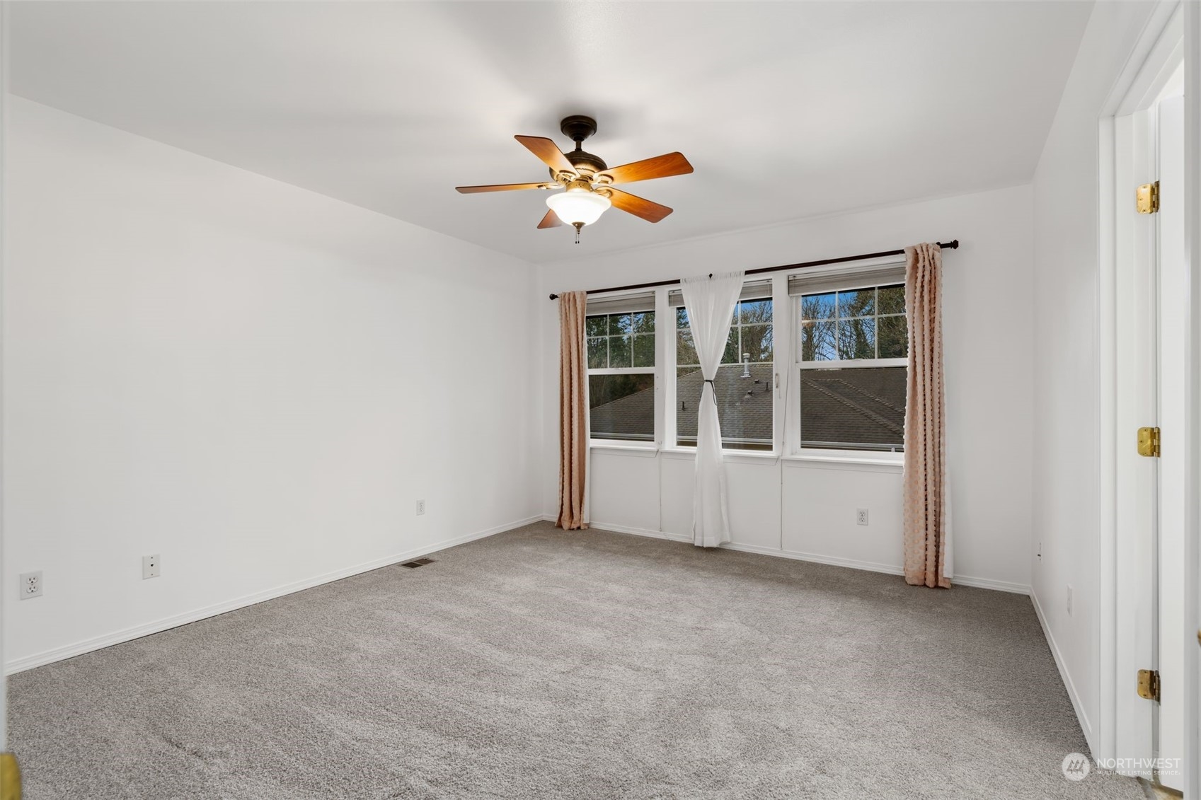 Master Bedroom: Large bedroom with ceiling fan and en-suite bathroom.