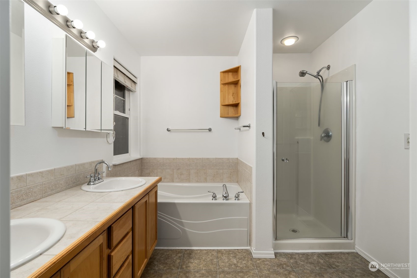 Primary Bathroom: Spacious bathroom with dual sinks, soaking tub, and a separate shower.