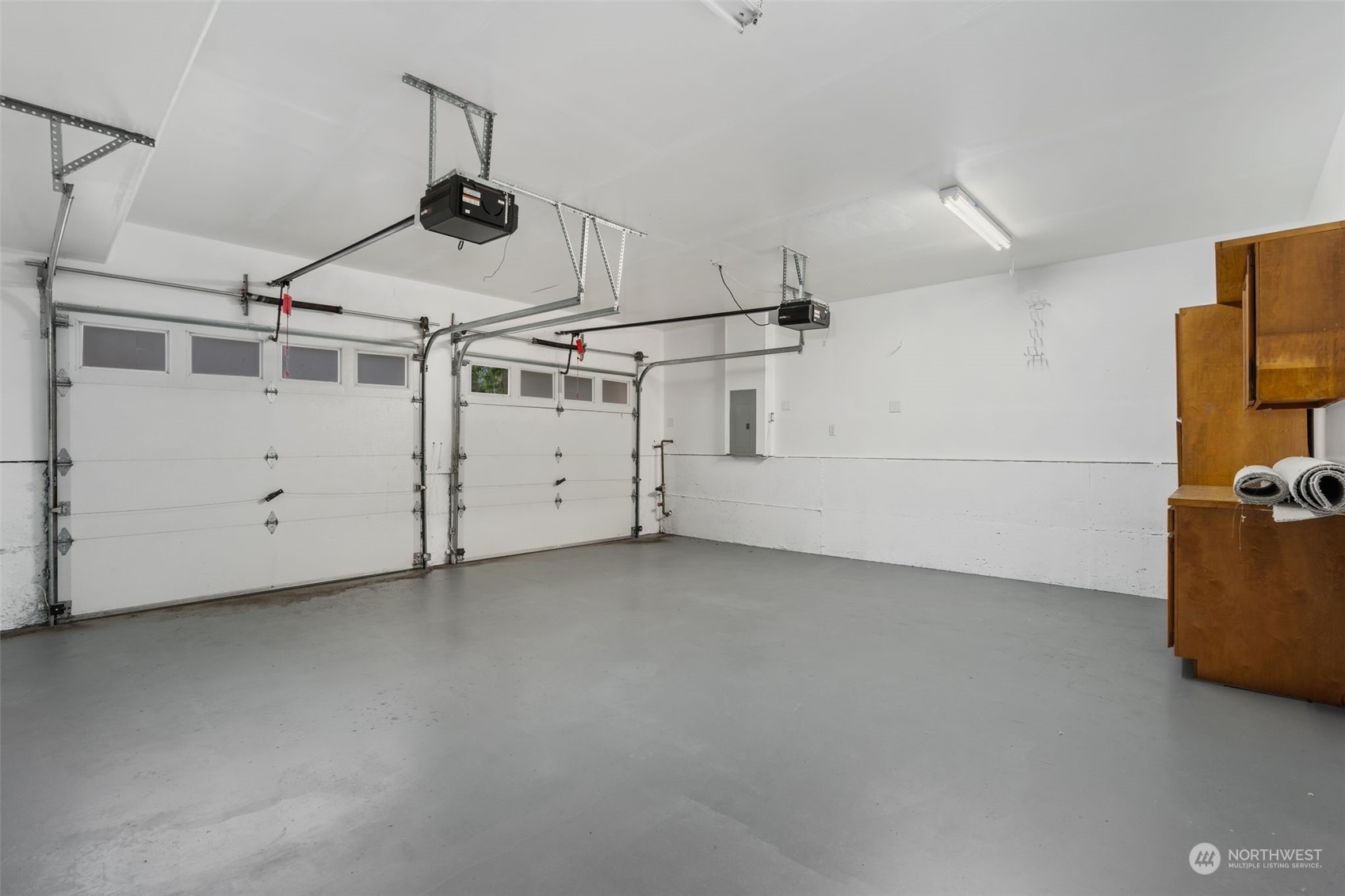 Garage: Two-car garage with epoxy floors and storage.