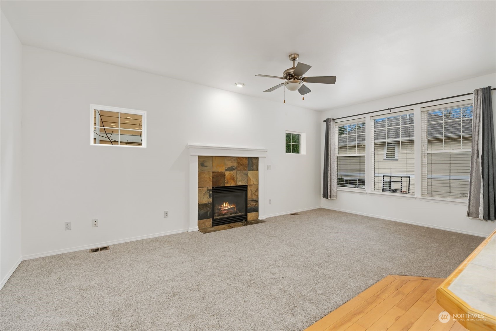 Living Room Fireplace - Cozy space with natural light and a warm fireplace.