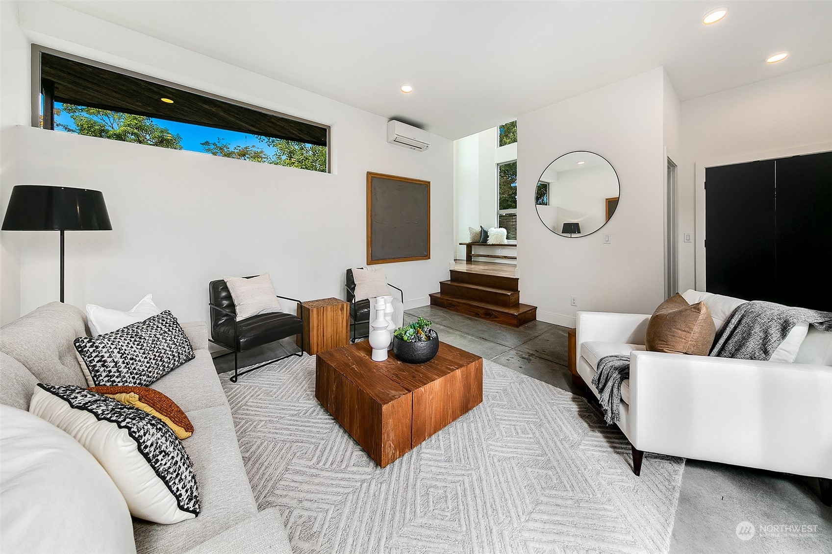 The crisp lines and neutral white base color offer a backdrop for the room's mix of furniture, artwork, and accessories.