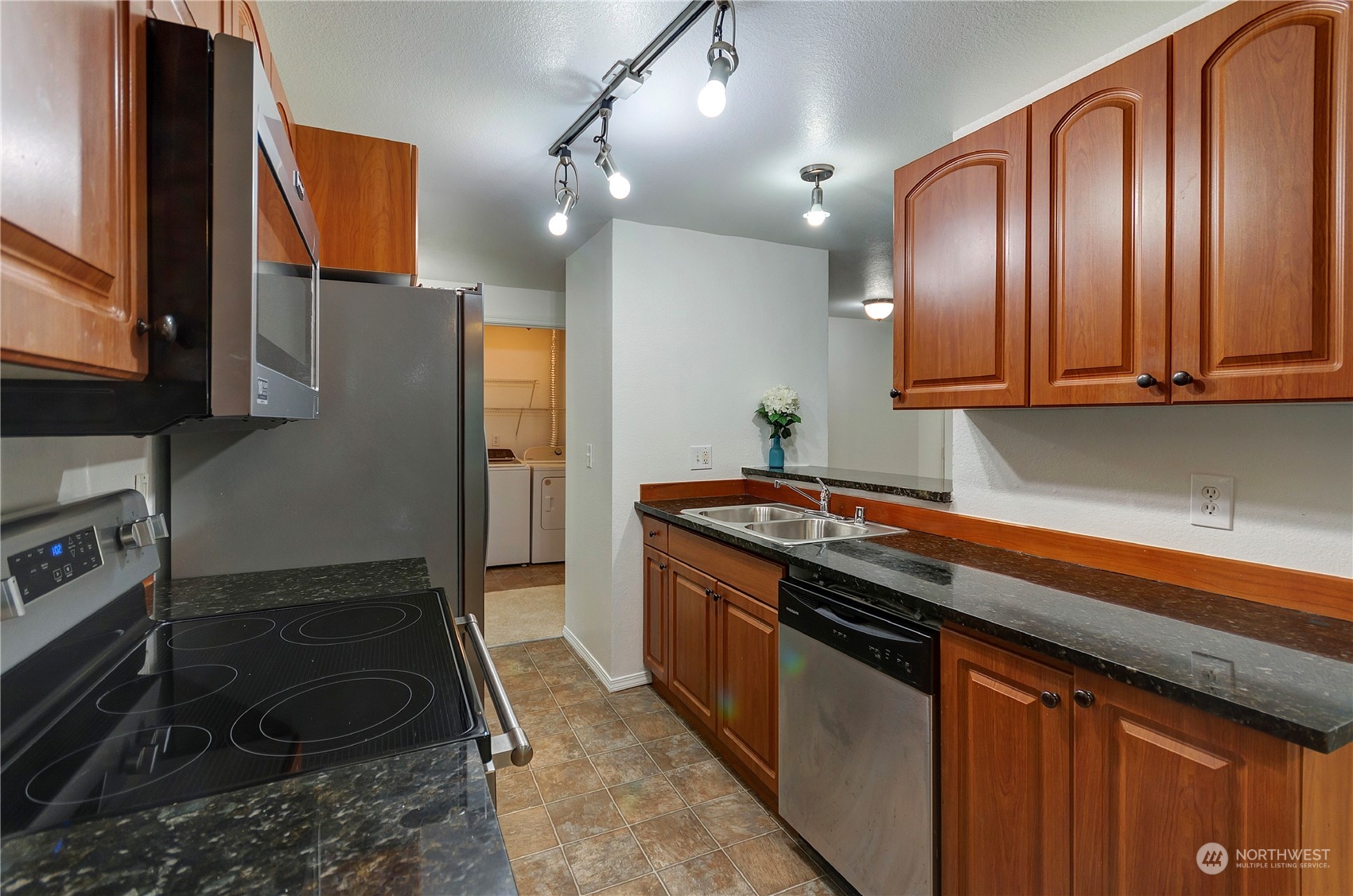 Second view of this updated kitchen that is open to family and dining rooms.  There is lots counter top space,cabinets and good sized pantry for all your cooking needs