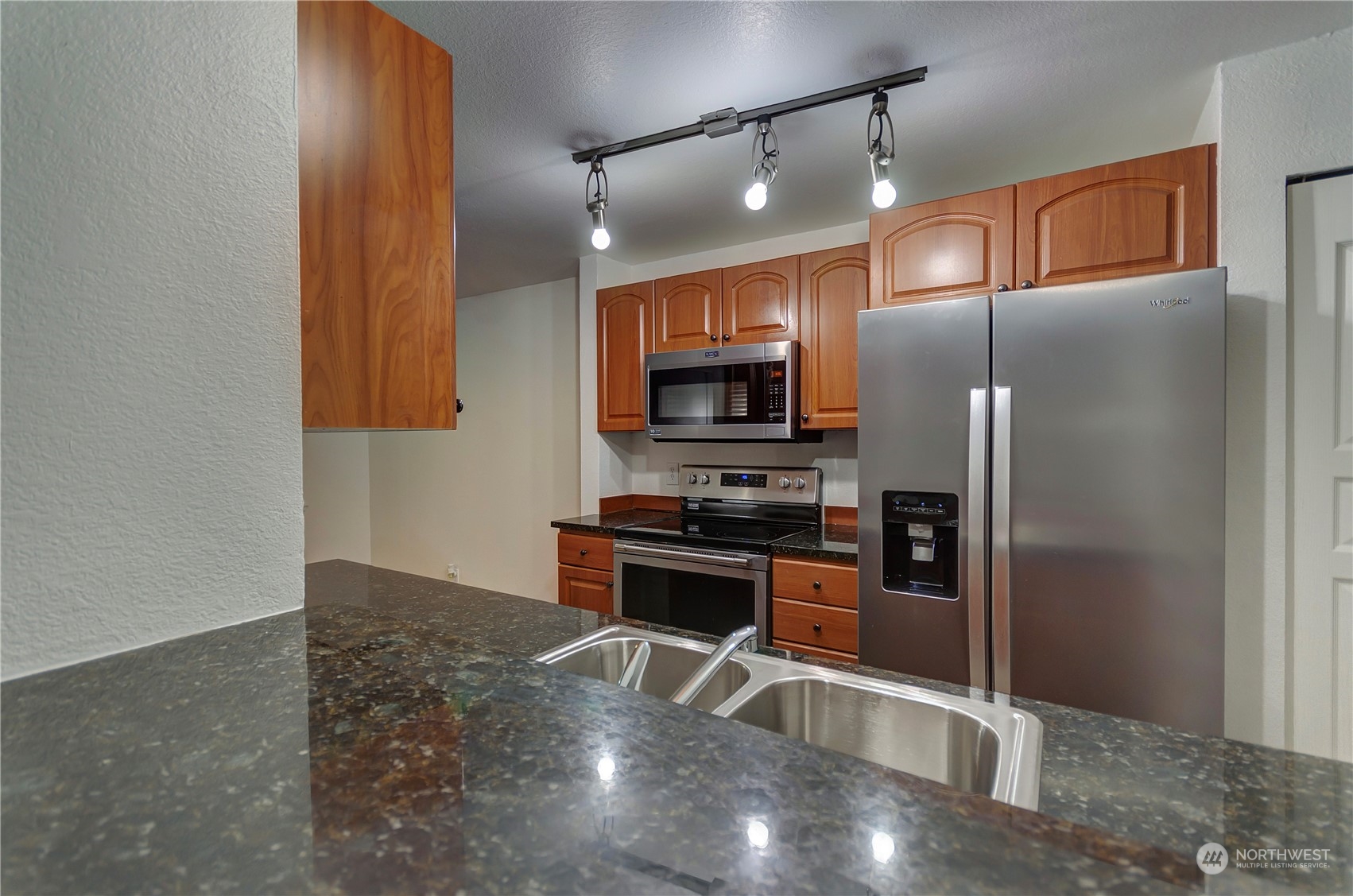 Here is view from kitchen breakfast bar looking into family room and front entry way.  Check out pantry door and light and bright colors to keep you happy while cooking