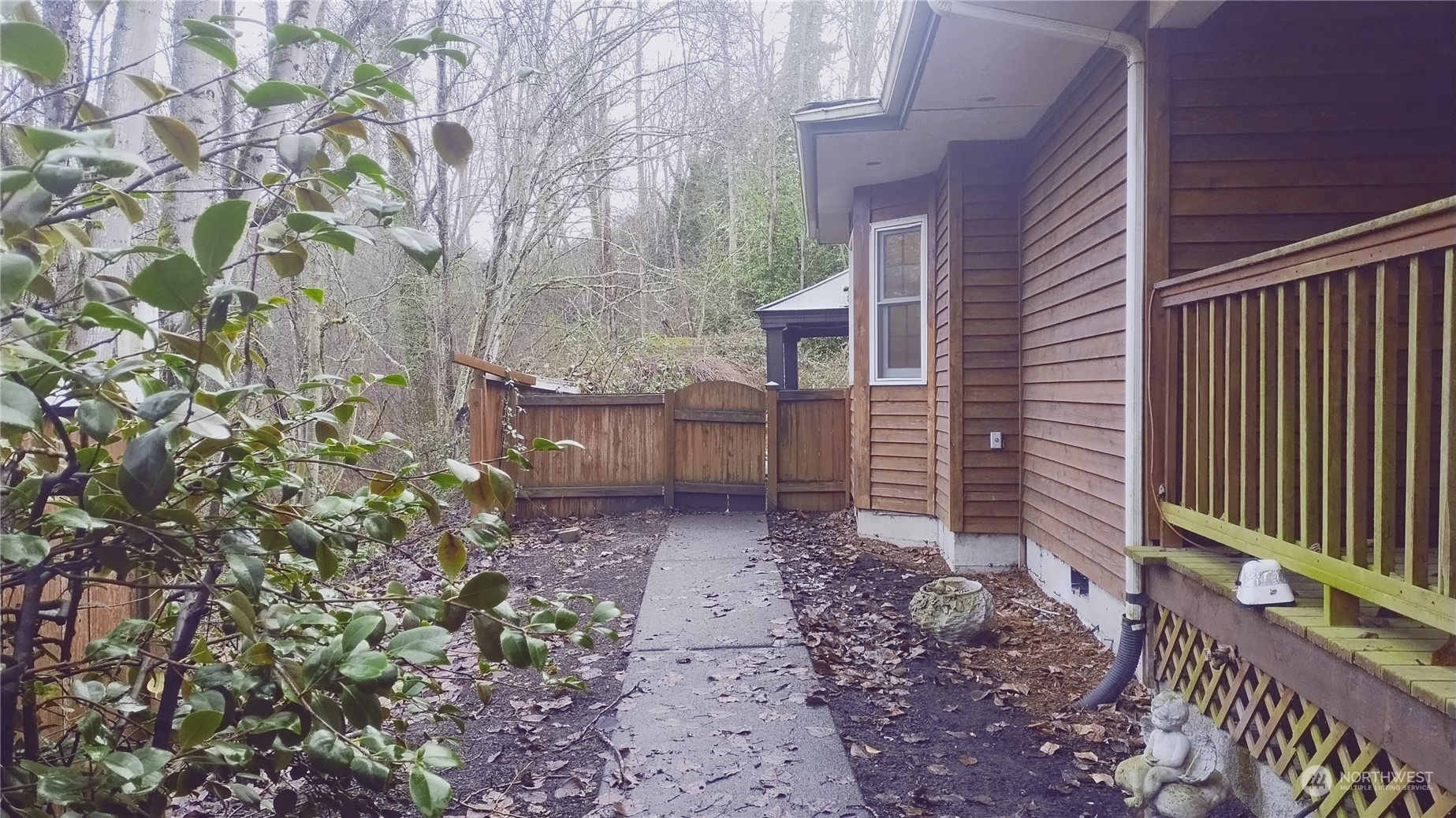 More pics to come.  From the front porch, which is lighted, this is the view of the L shaped driveway which can fit plenty of vehicles.  This would be a perfect in home business property with the parking situation and the house floor plan.