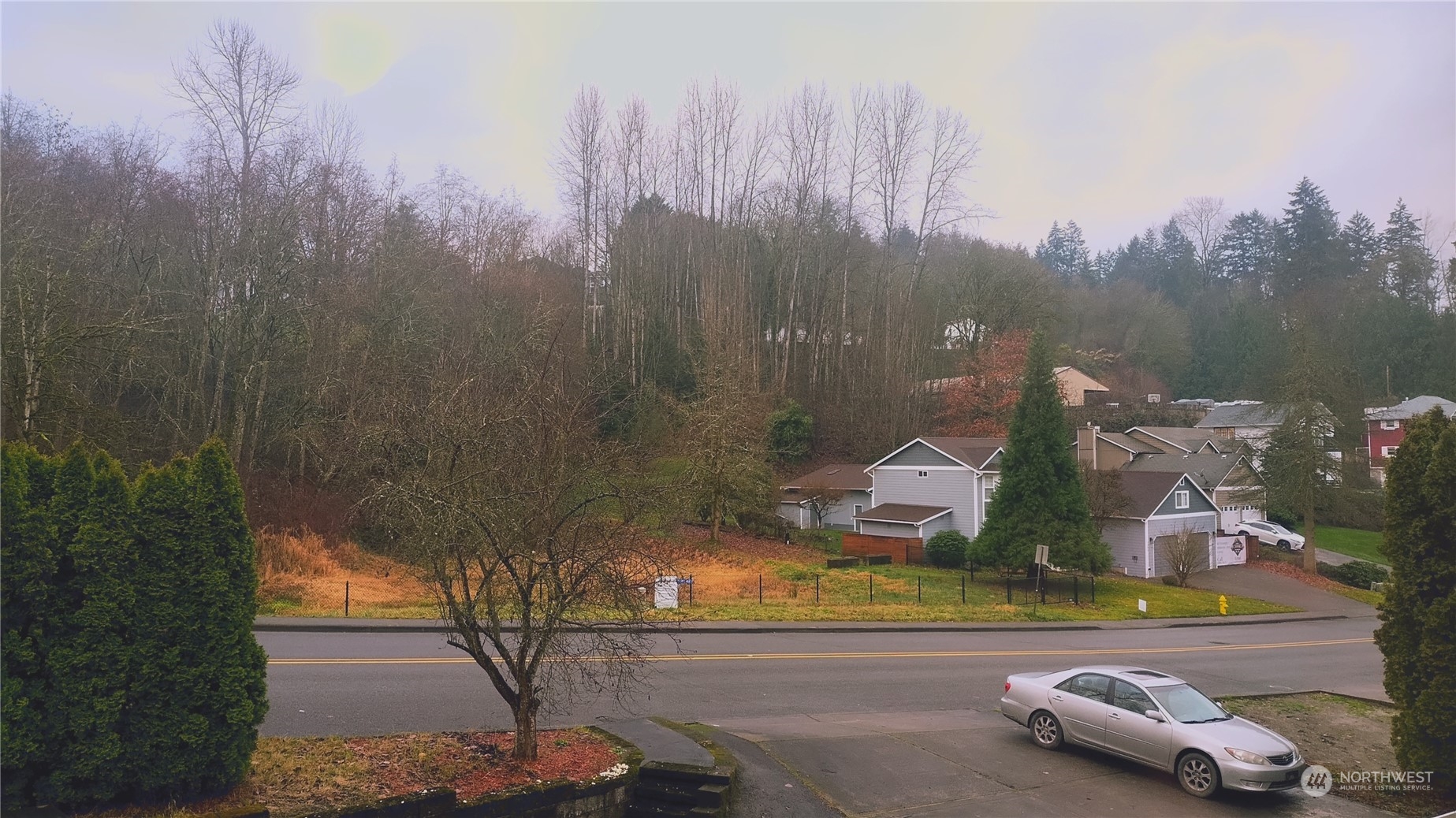 More pics to come.  From the front porch, which is lighted, this is the view of the L shaped driveway which can fit plenty of vehicles.  This would be a perfect in home business property with the parking situation and the house floor plan.