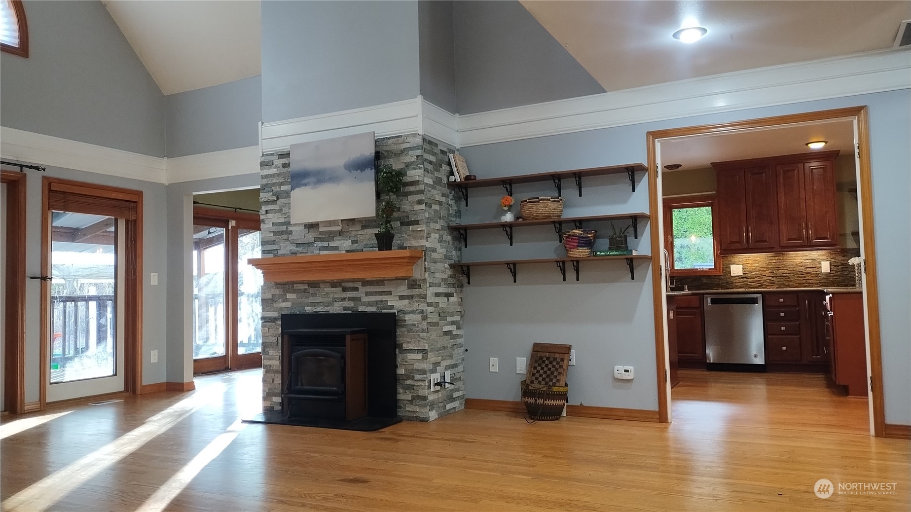 Living room with hardwood floors and glass doors leading to deck and backyard.  More pics to come.