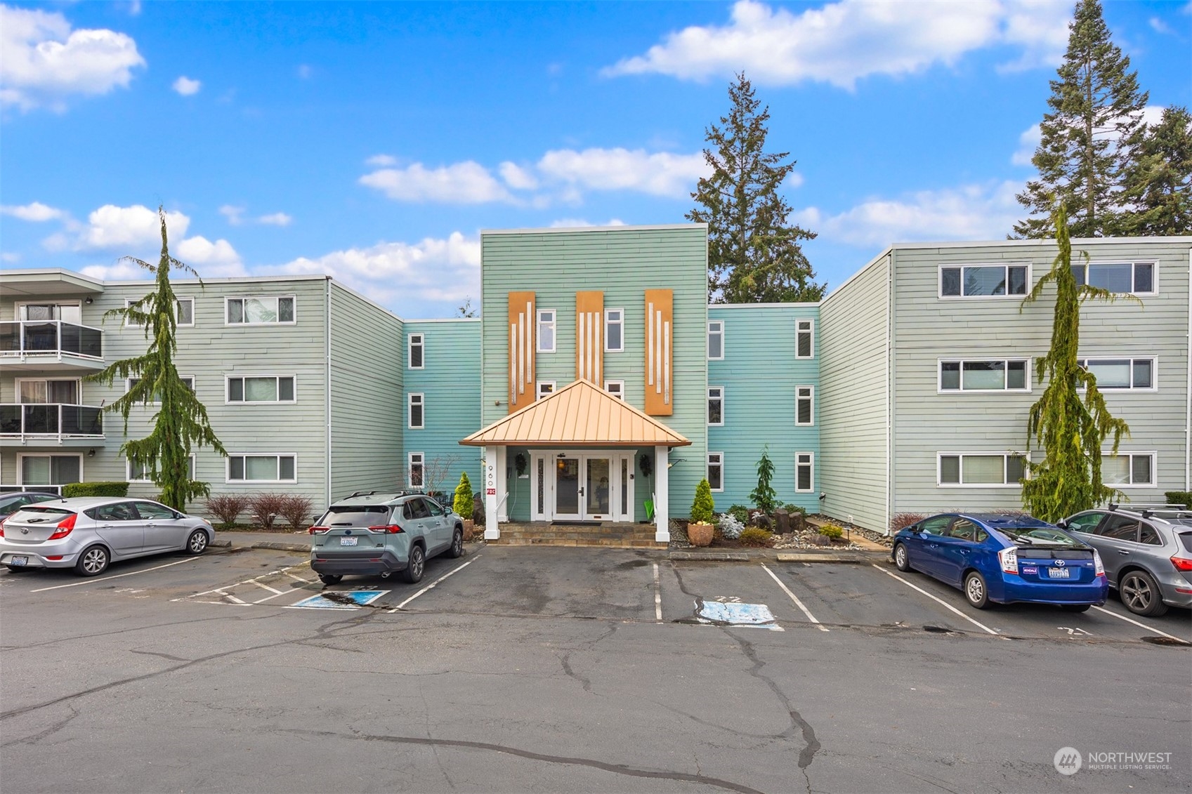 Mid-century building with elevator and reserved parking near the front door.