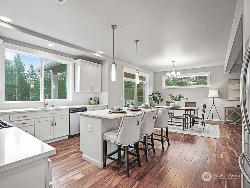 Open Concept Kitchen Overlooking Garden Space and Treeline