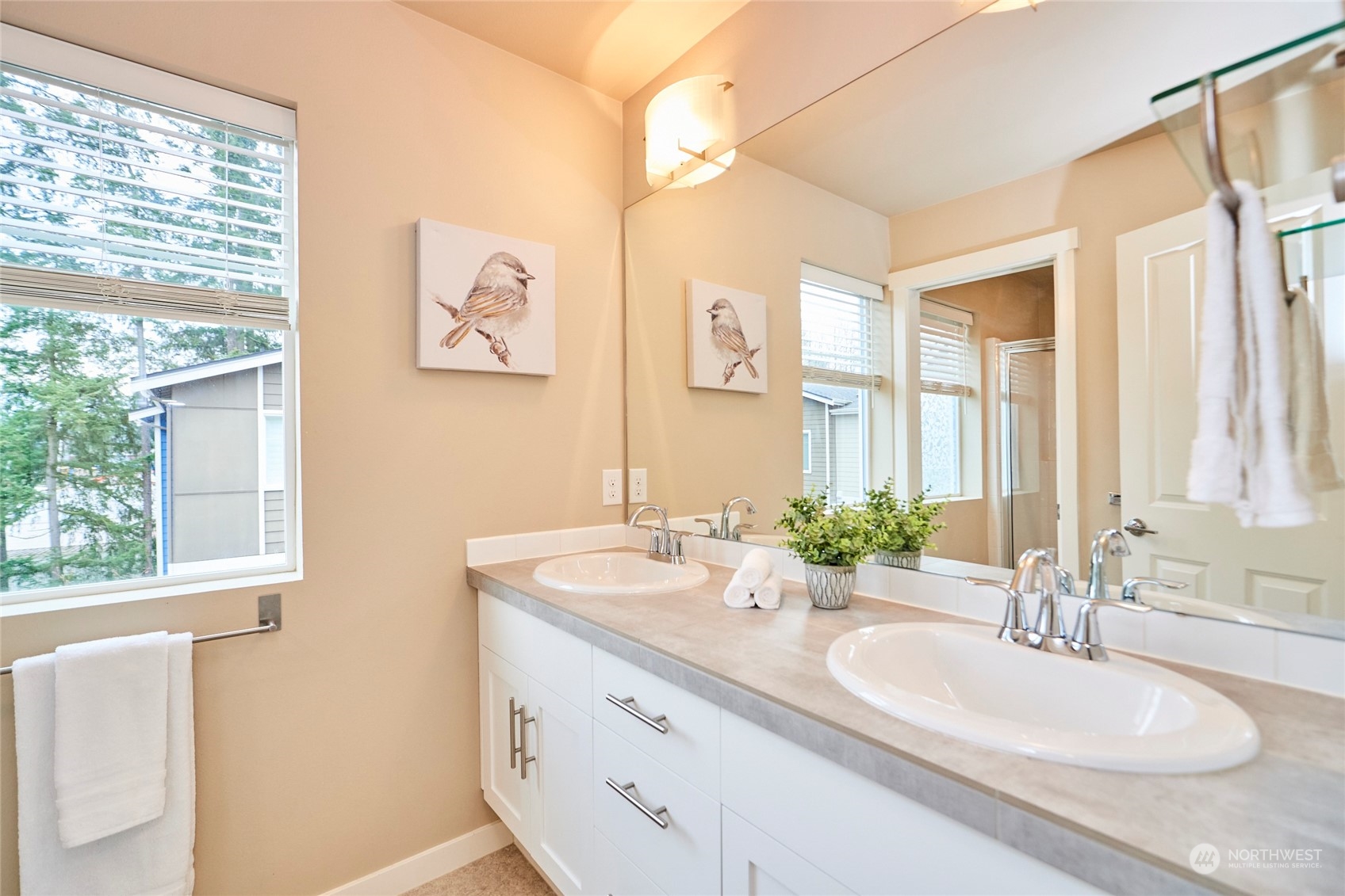 The bathroom off bedroom #2 features a double sink vanity and a large shower surround.