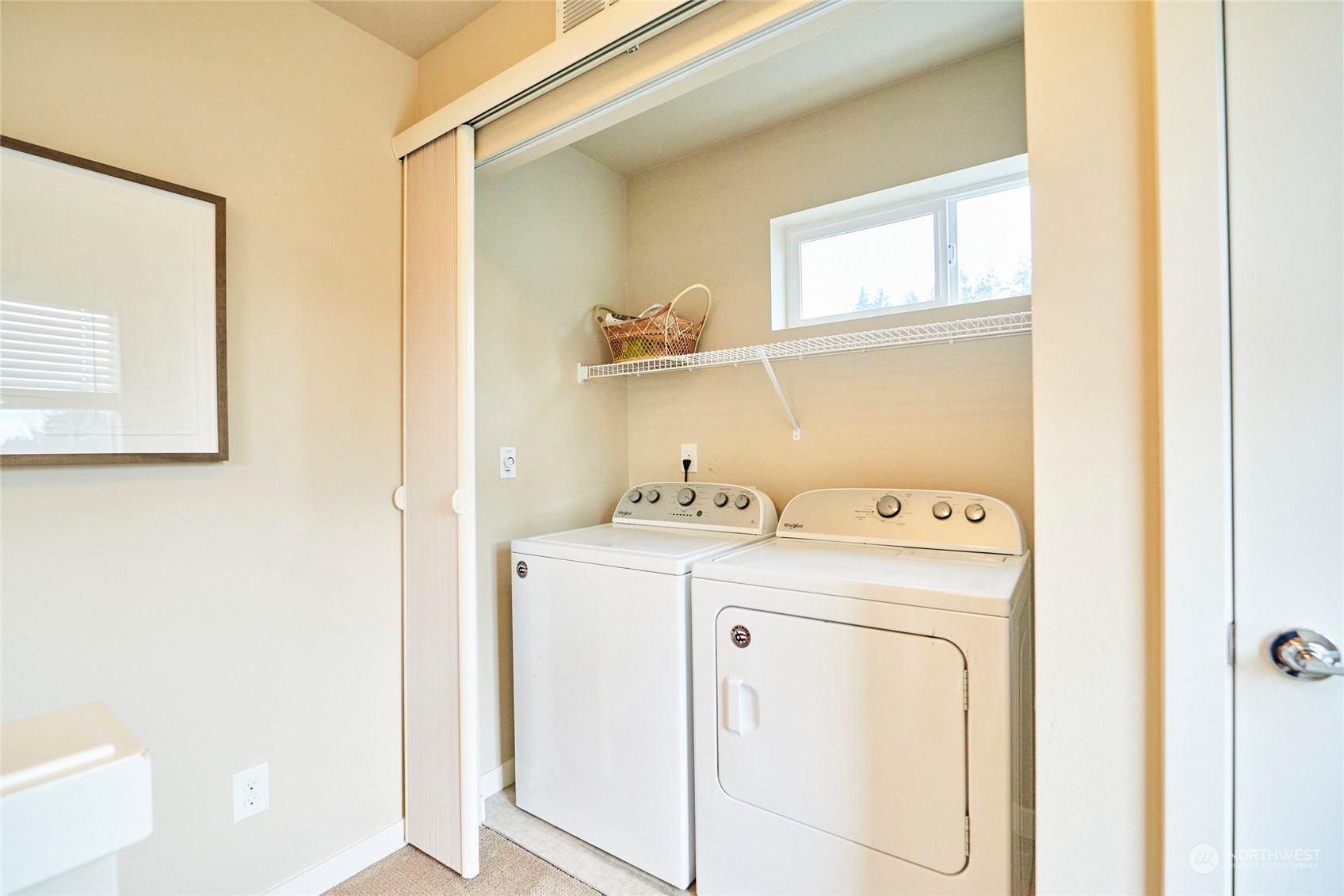 Off the hallway on the upstairs level is the washer and dryer and additional storage closet.