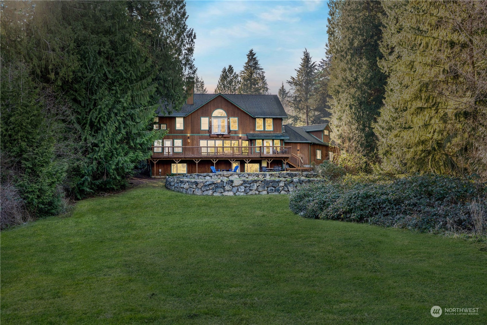 Sprawling deck seamlessly extends the living space outdoors, making it the perfect place for hosting gatherings, dining alfresco, or simply soaking in the stunning lake views.