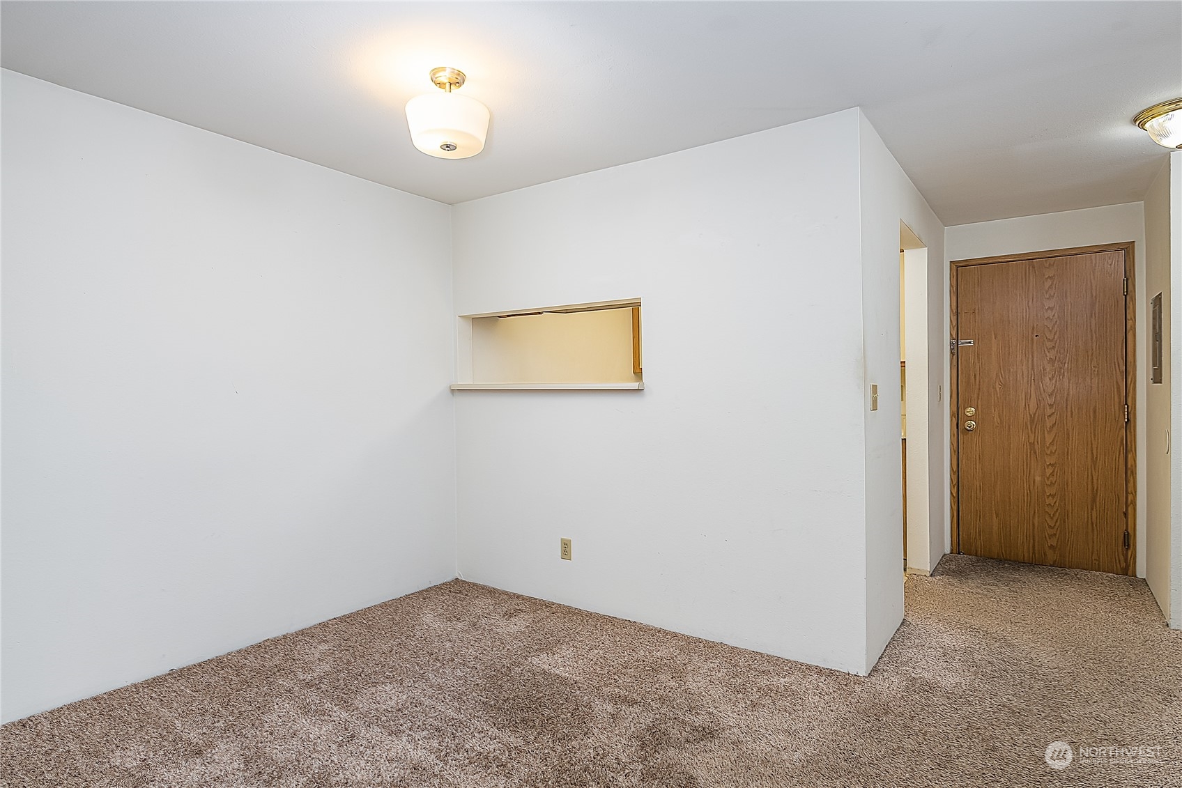 Dining area, with hallway and front door on the right