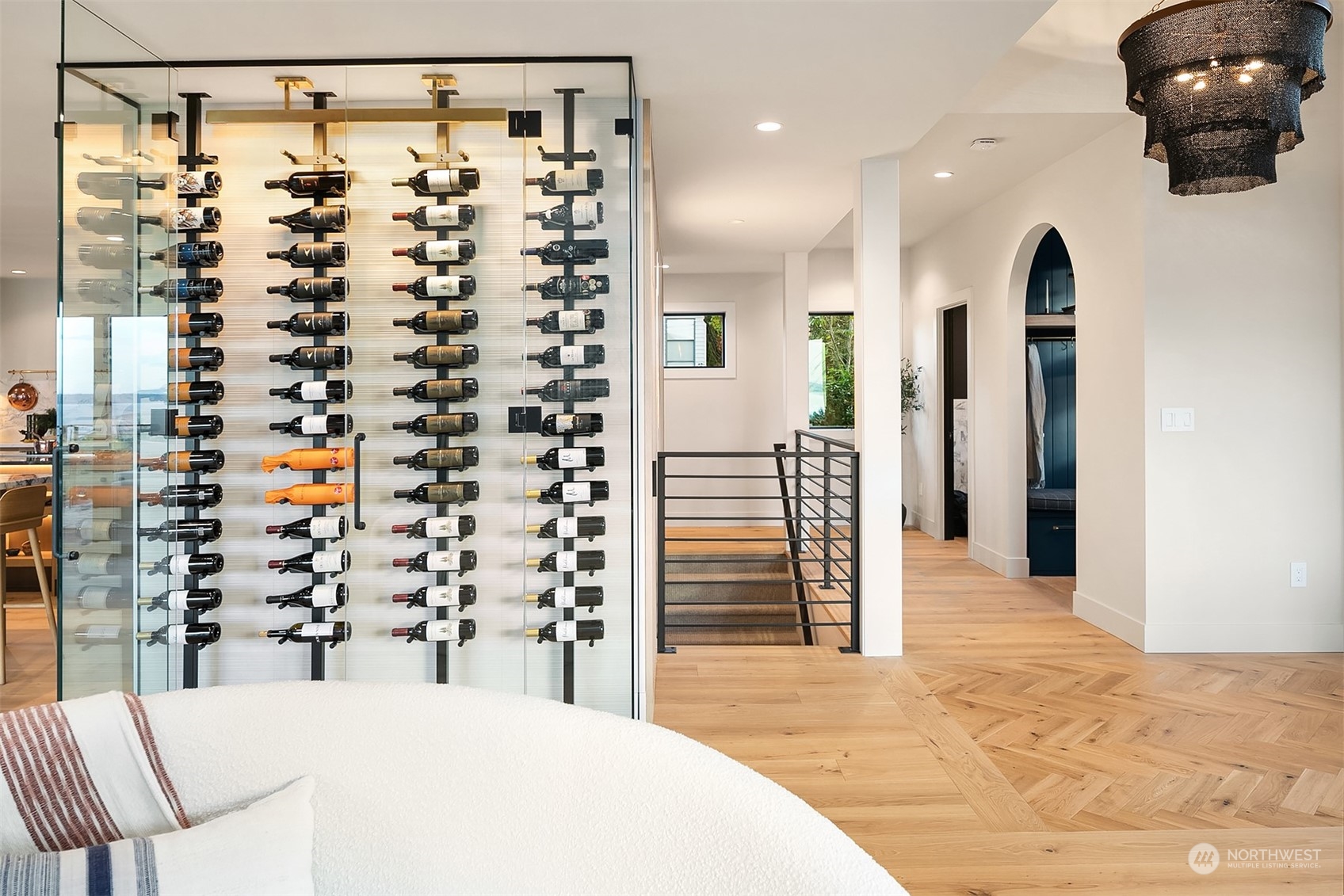 60 bottle wine storage showing chandelier at front door, mudroom on right and stairs going down to lower level